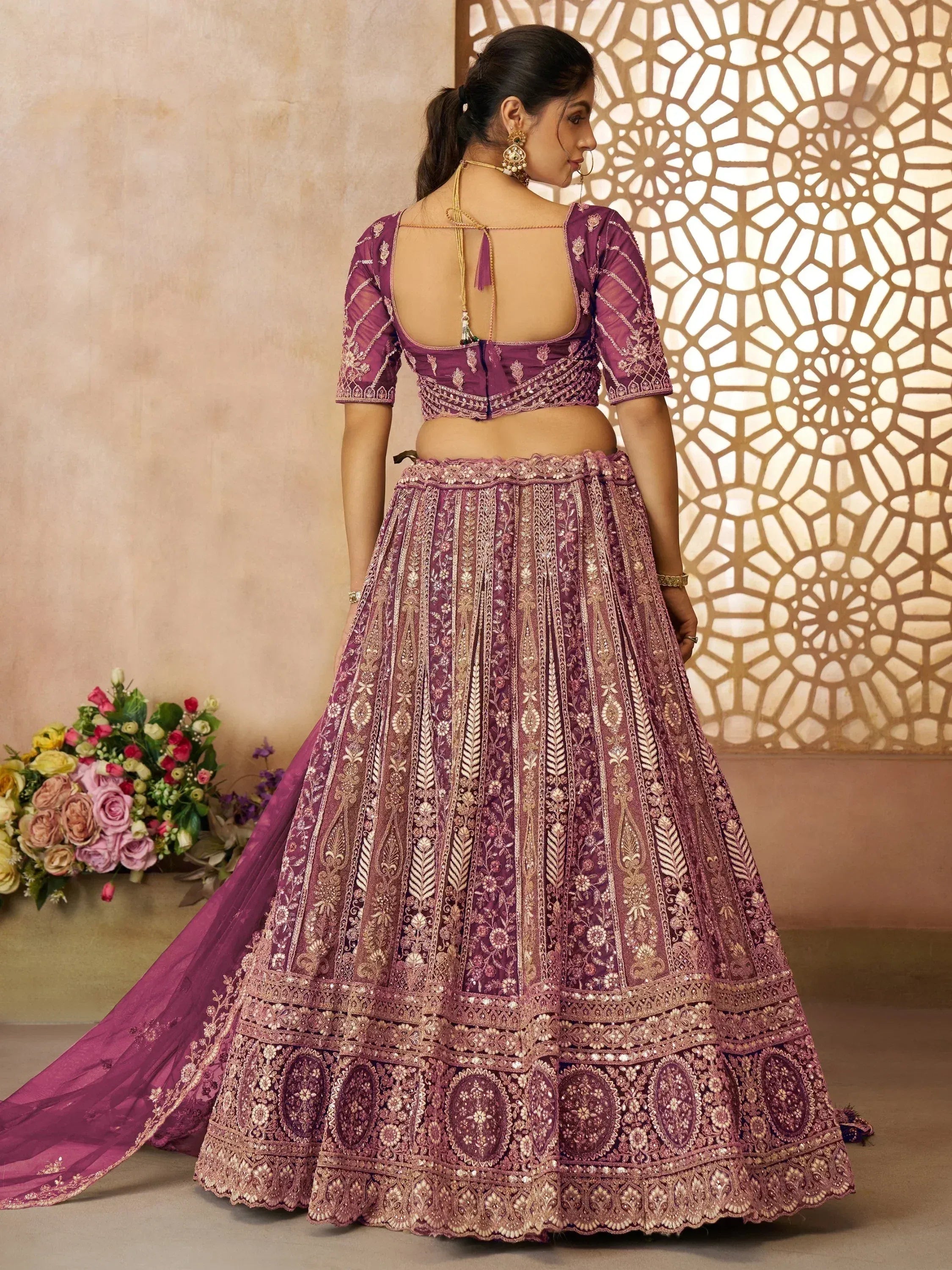 Purple designer lehenga choli with gold embroidery, back view, ethnic wear for weddings