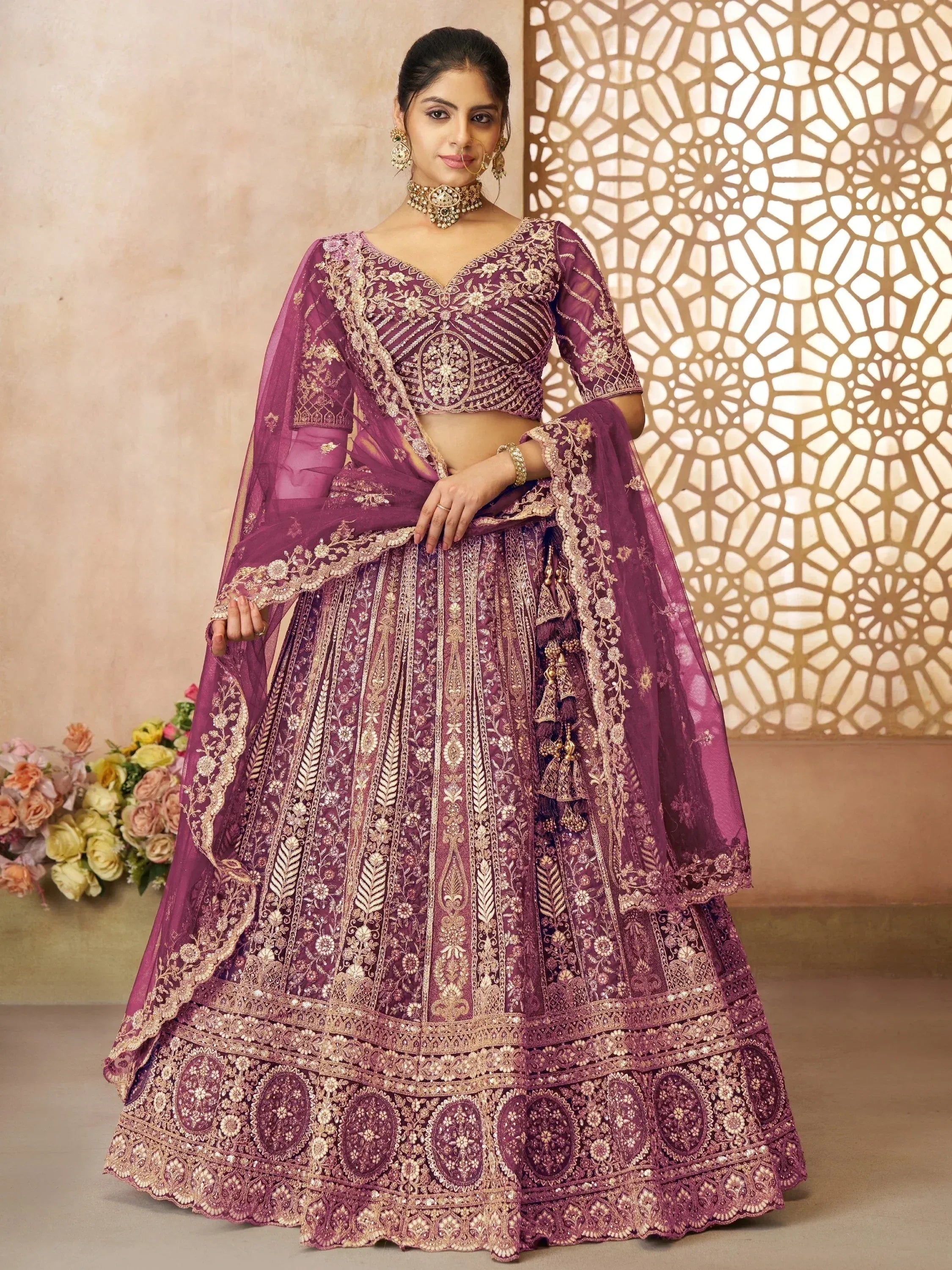 Elegant purple designer lehenga choli with gold embroidery, perfect for weddings and festive occasions.