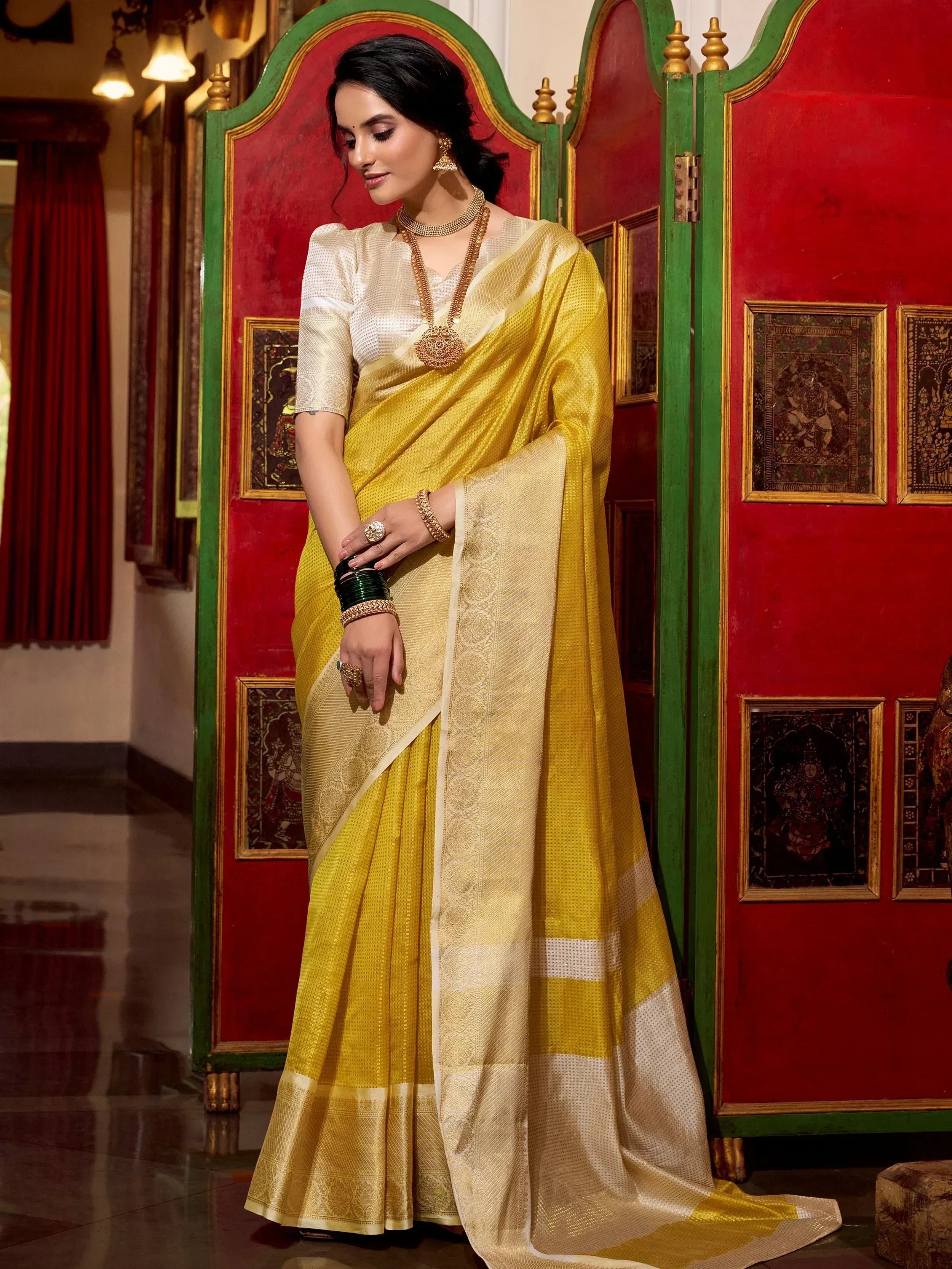 Elegant yellow and cream designer saree with gold embroidery, perfect for Indian ethnic occasions
