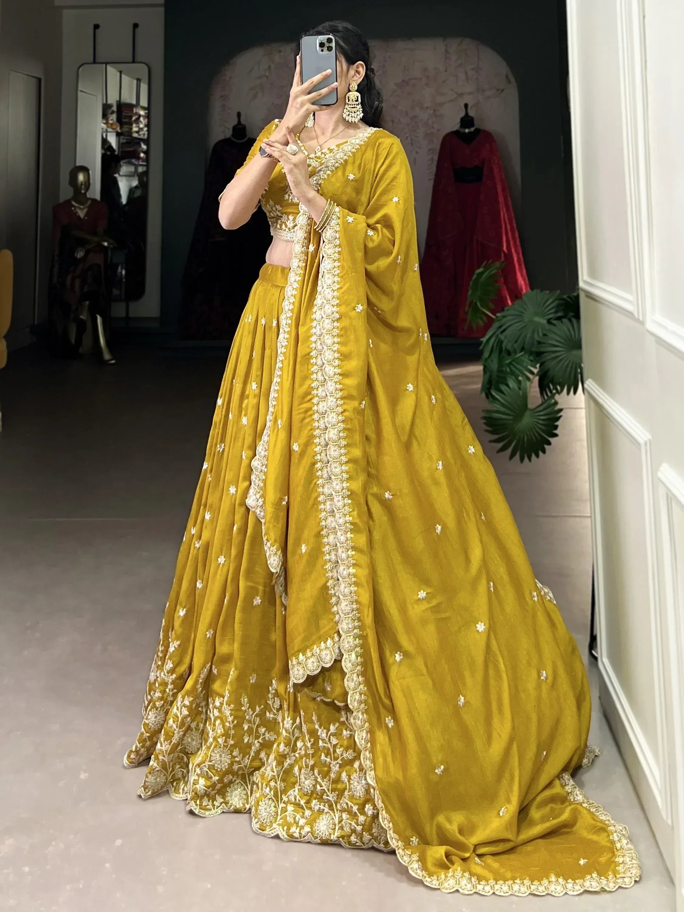 Mustard yellow designer lehenga choli with white floral embroidery, perfect for Indian ethnic occasions.