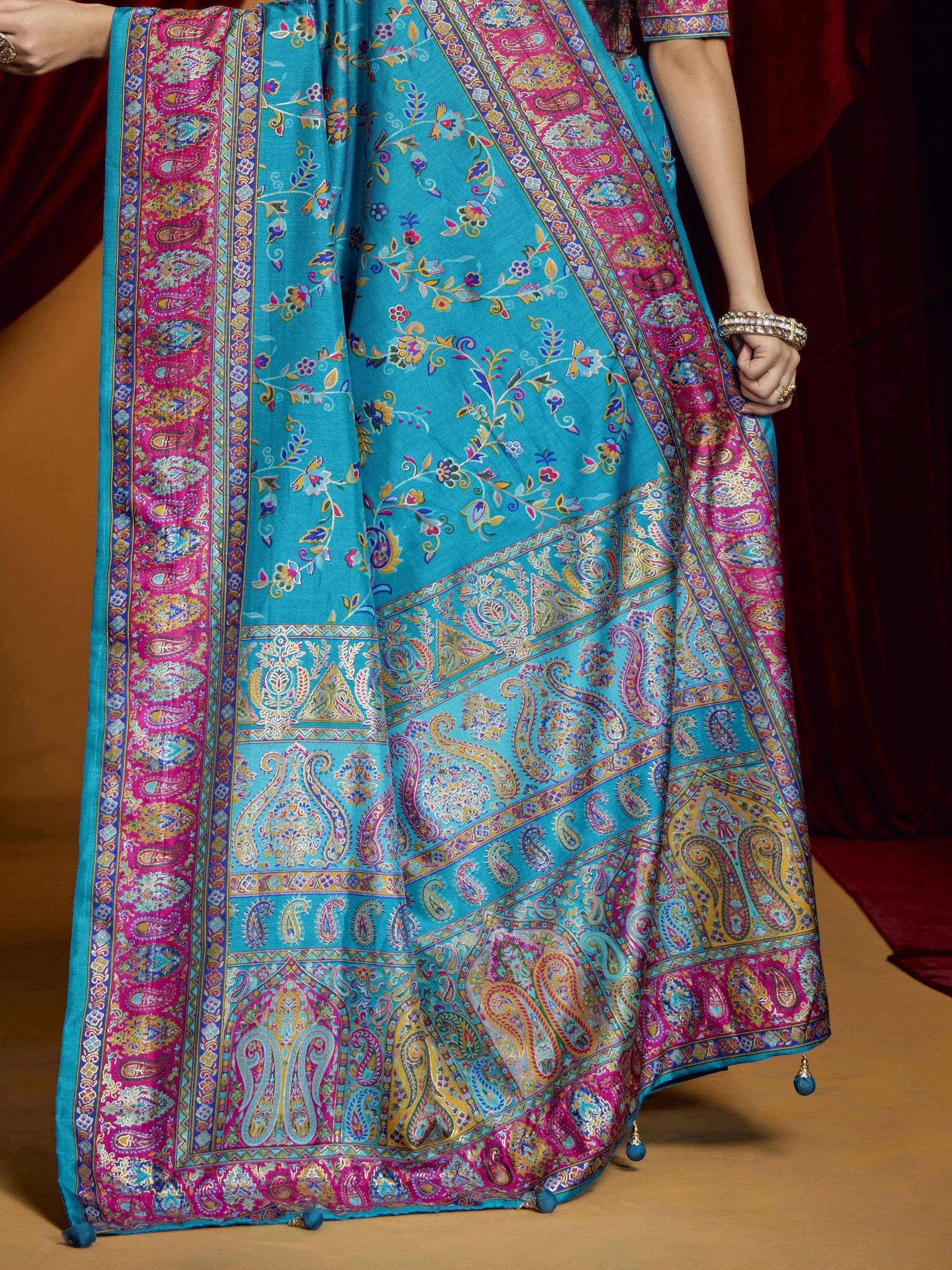 Turquoise and pink designer saree with intricate paisley and floral embroidery, perfect for Indian ethnic wear.
