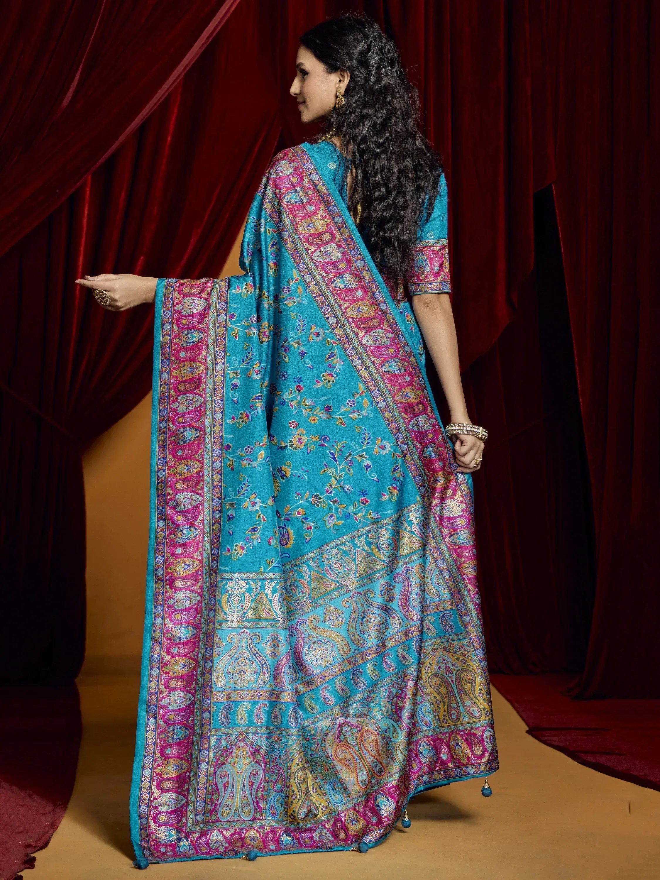 Woman in turquoise ethnic saree with pink paisley border, Indian designer wear
