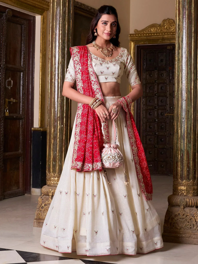 Cream embroidered lehenga choli with red dupatta, perfect for Indian weddings and festive occasions