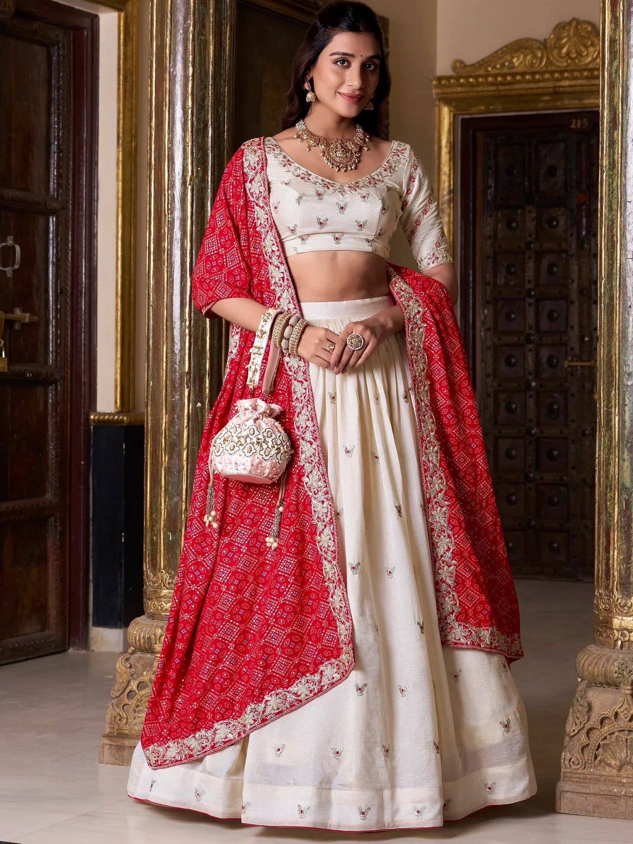 Cream embroidered lehenga choli with red dupatta, perfect for Indian weddings and festive occasions