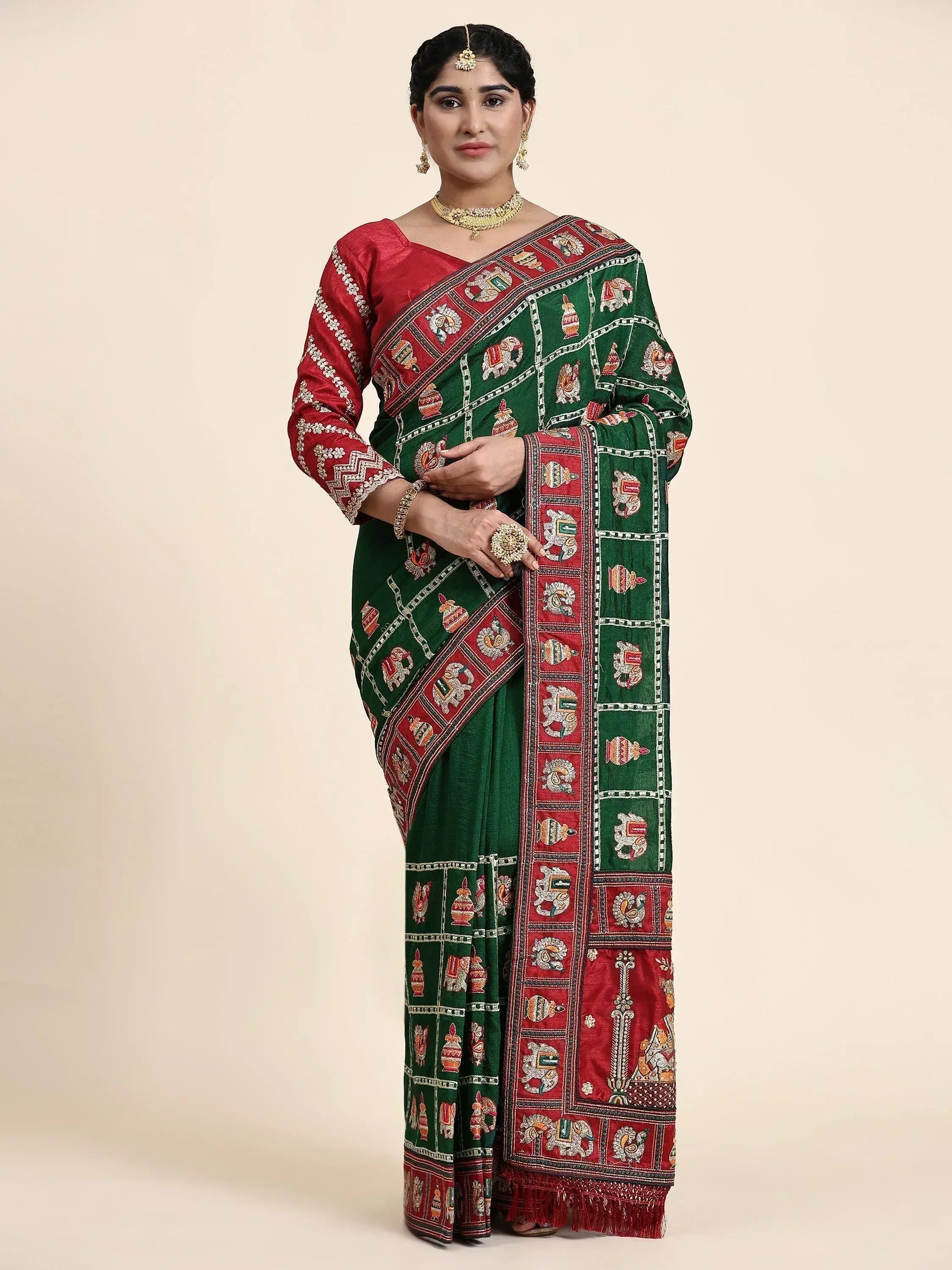 Green and red embroidered saree with elephant motifs, paired with matching blouse, ideal for Indian ethnic wear.