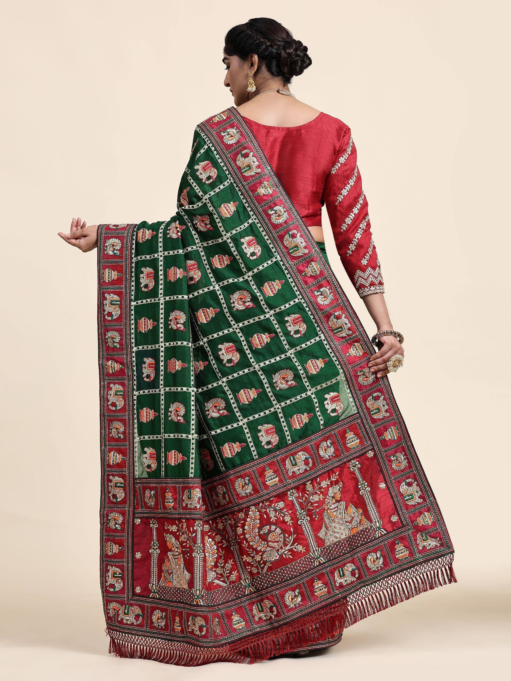 Woman in red and green embroidered saree with elephant motifs, showcasing Indian ethnic wear design
