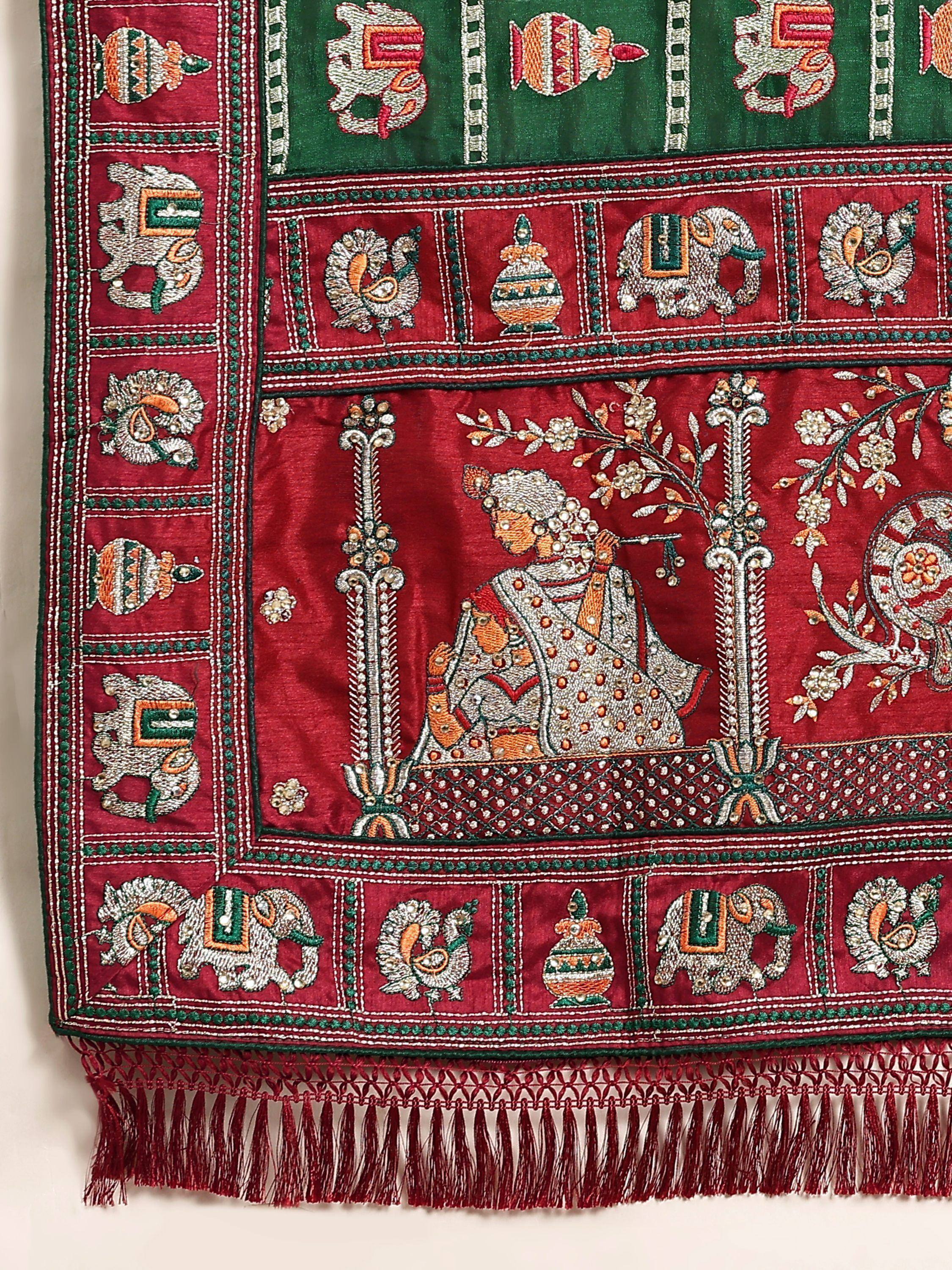 Richly embroidered Indian ethnic fabric with elephants, peacocks, and traditional motifs in red and green