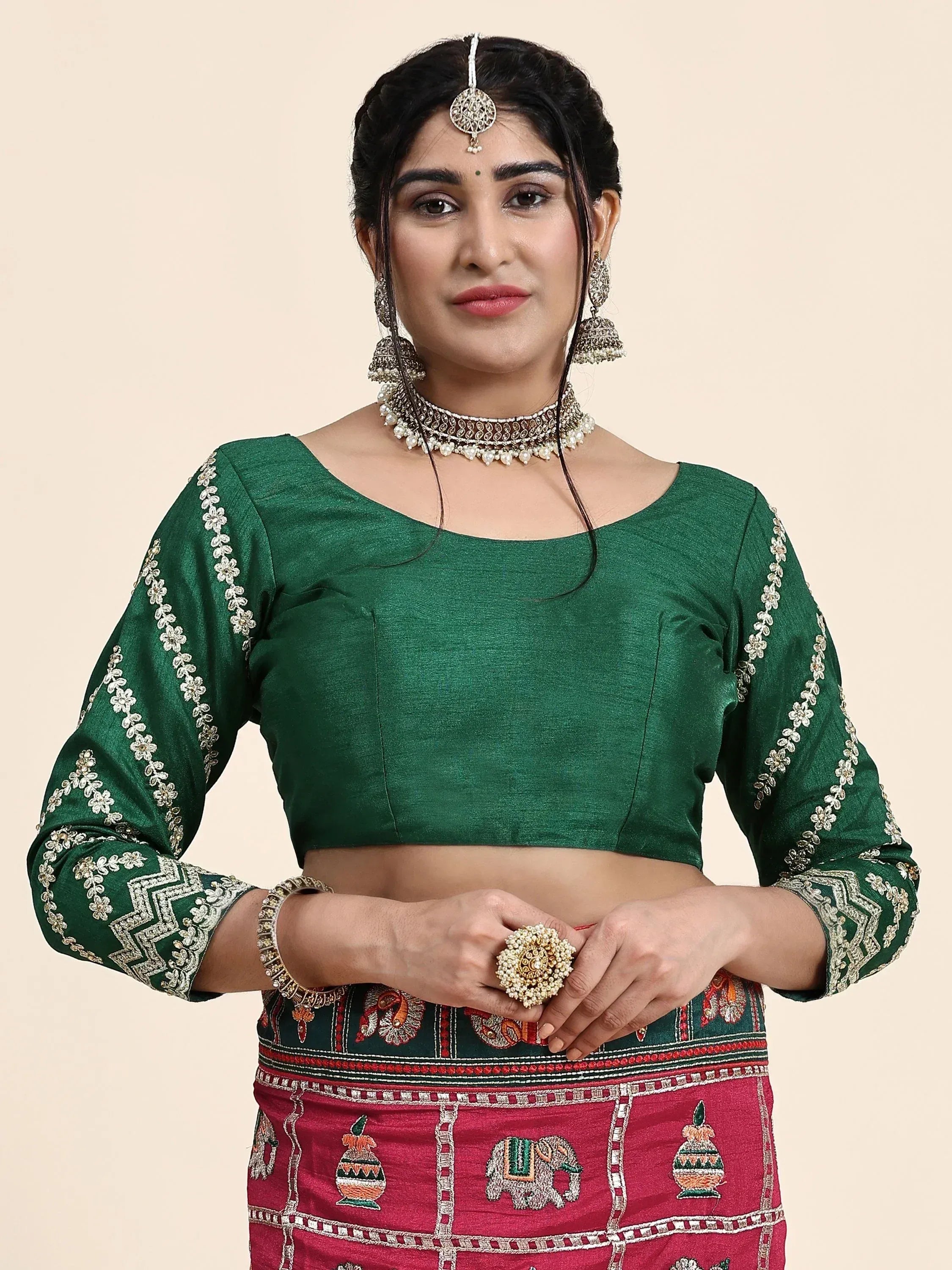 Green embroidered blouse with floral sleeves paired with red patterned lehenga, traditional Indian ethnic wear