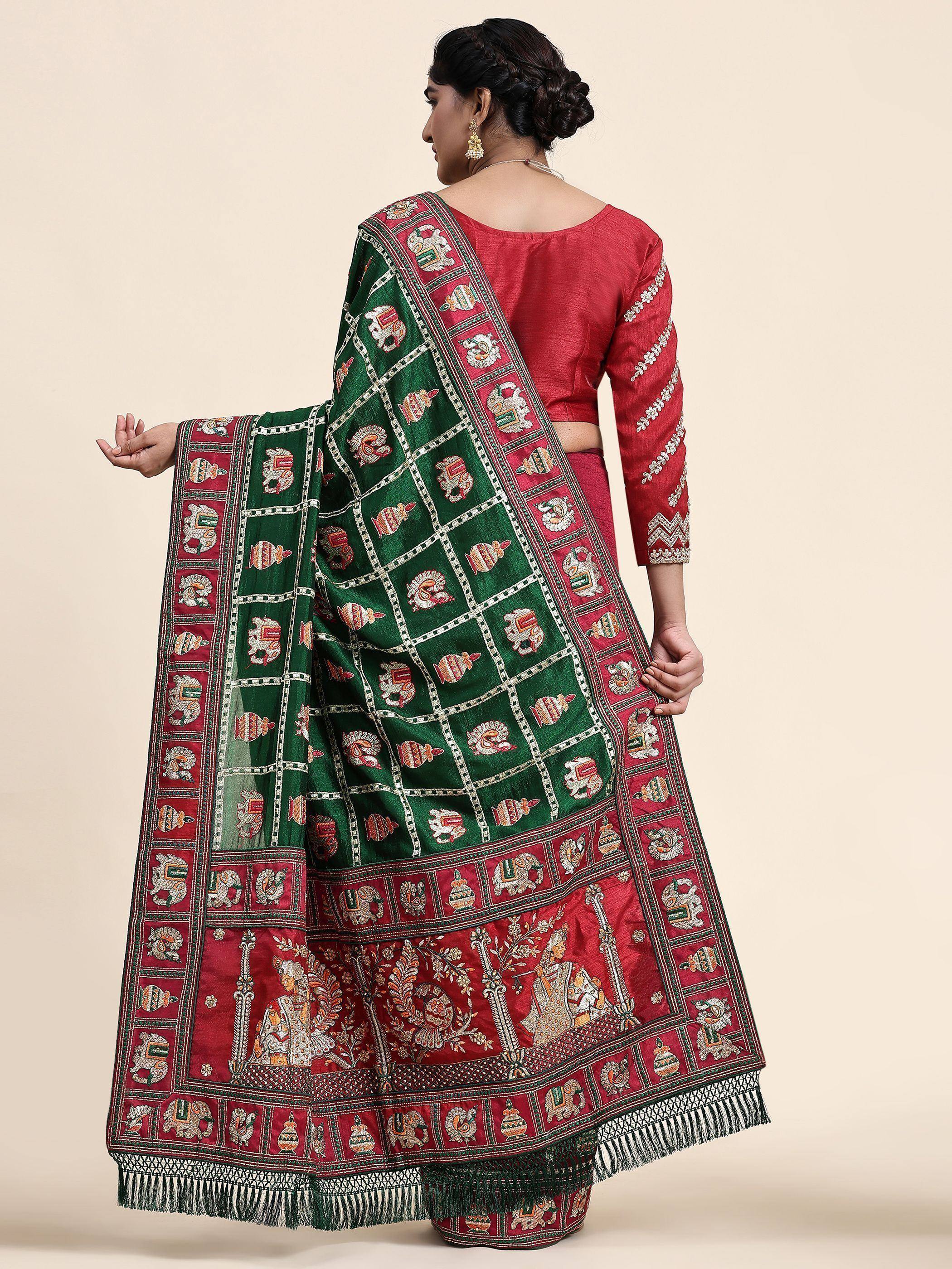 Red and green embroidered Indian saree with elephant motifs and traditional border design