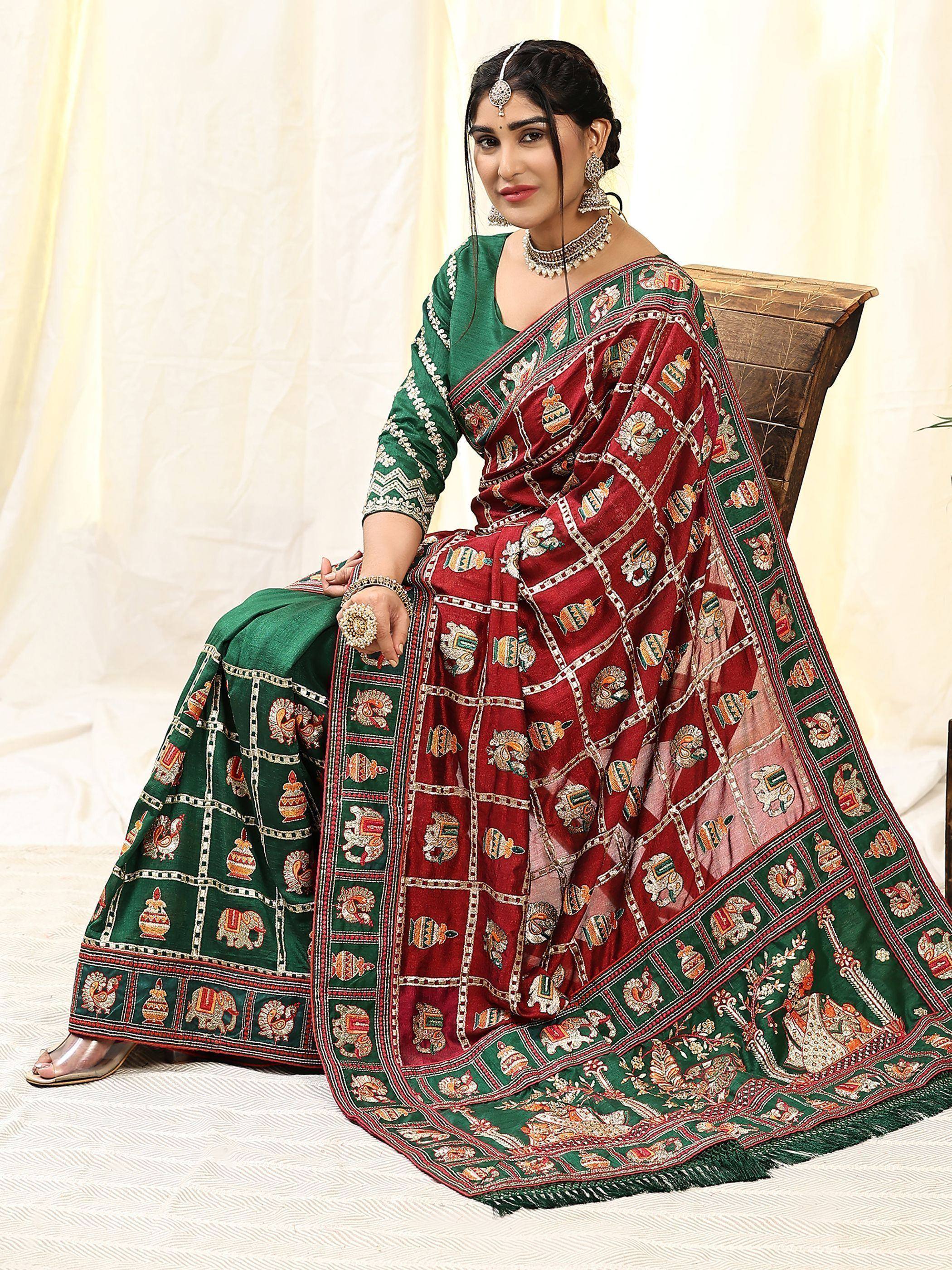 Woman in green and maroon embroidered lehenga choli with traditional Indian motifs, perfect for ethnic occasions.