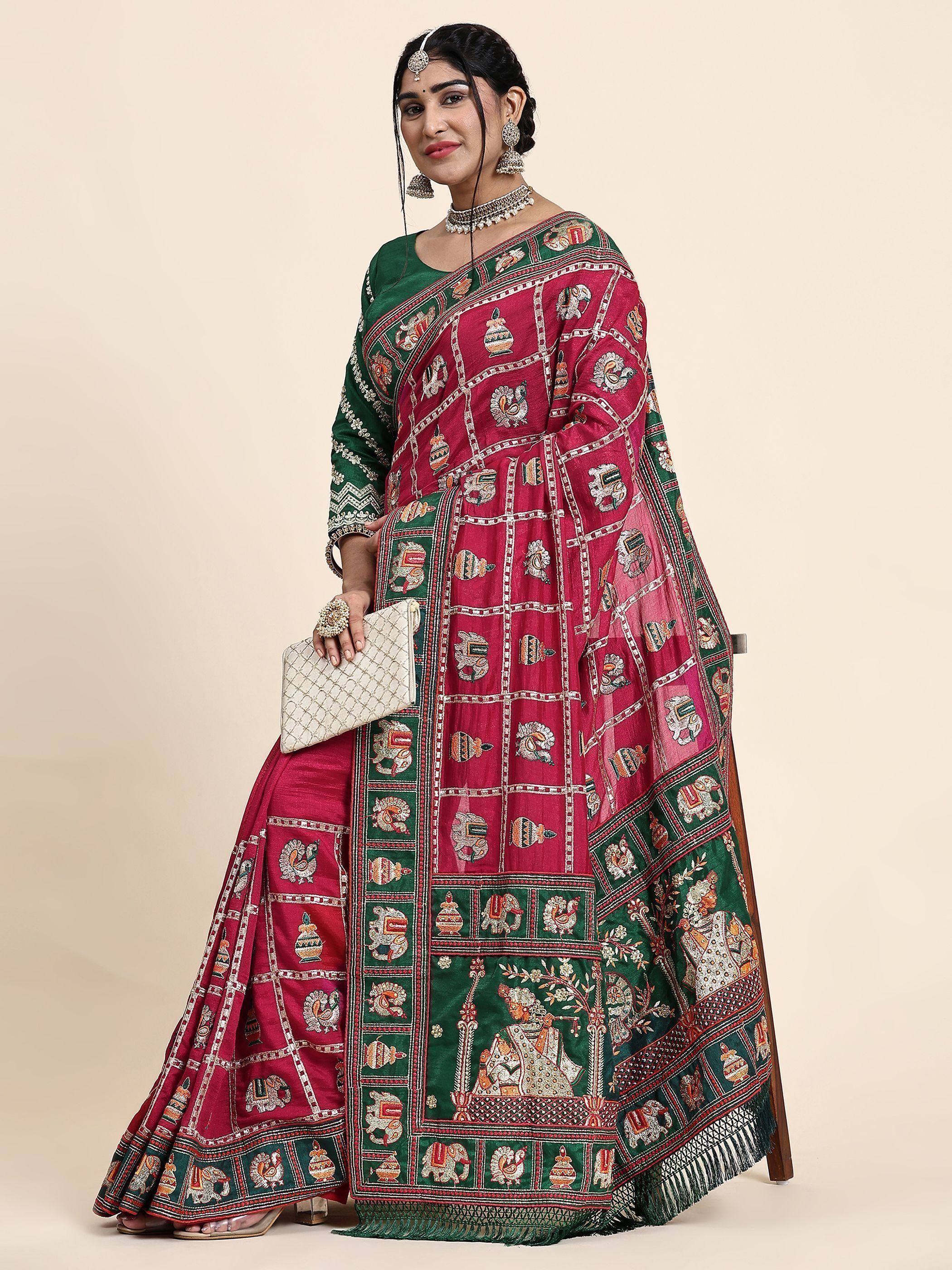 Woman in maroon and green embroidered lehenga choli with traditional motifs, ethnic Indian wear