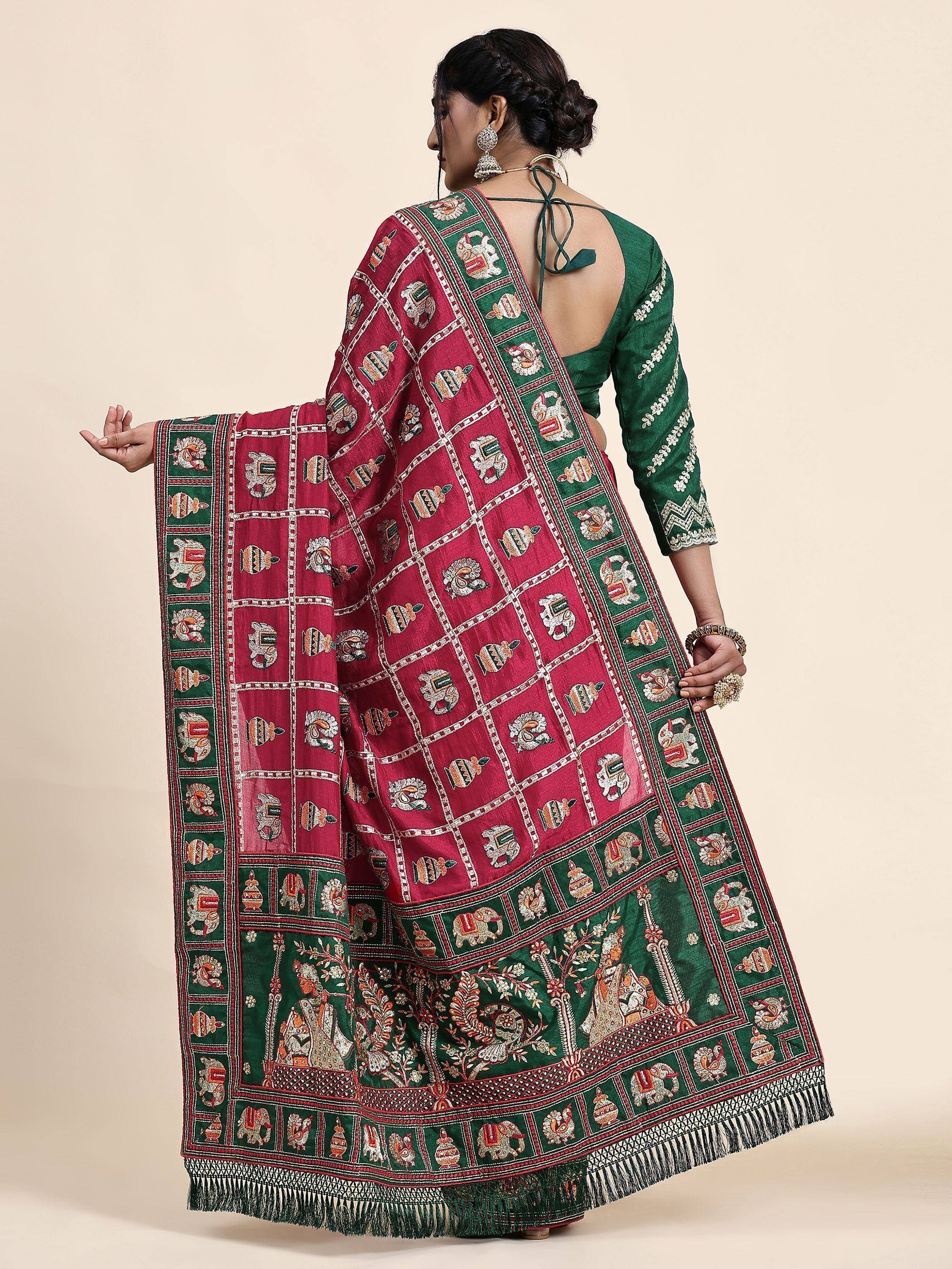 Woman in green backless blouse with maroon and green embroidered saree featuring elephant motifs and traditional patterns