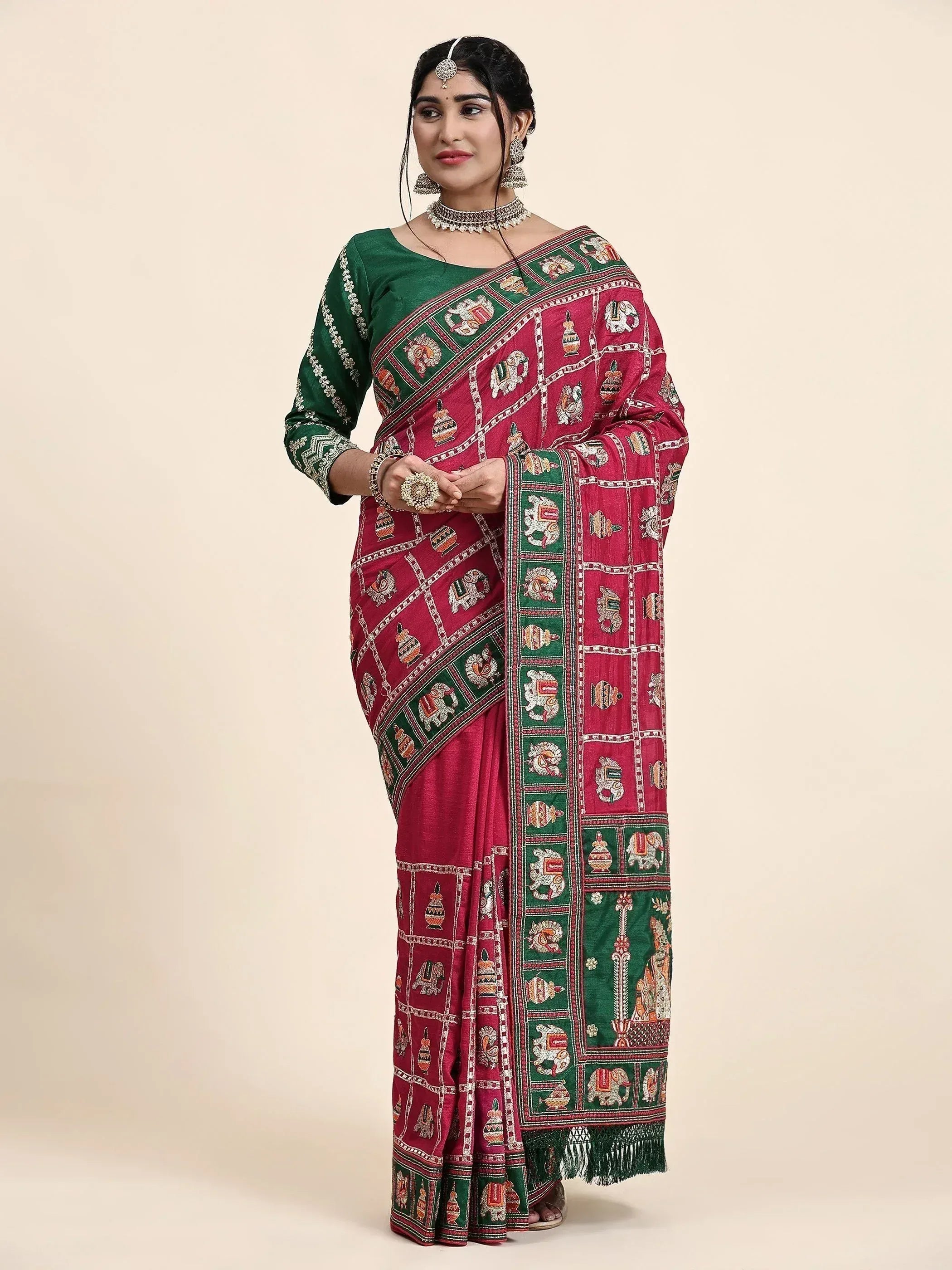 Woman in red and green embroidered saree with elephant motifs, traditional Indian ethnic wear