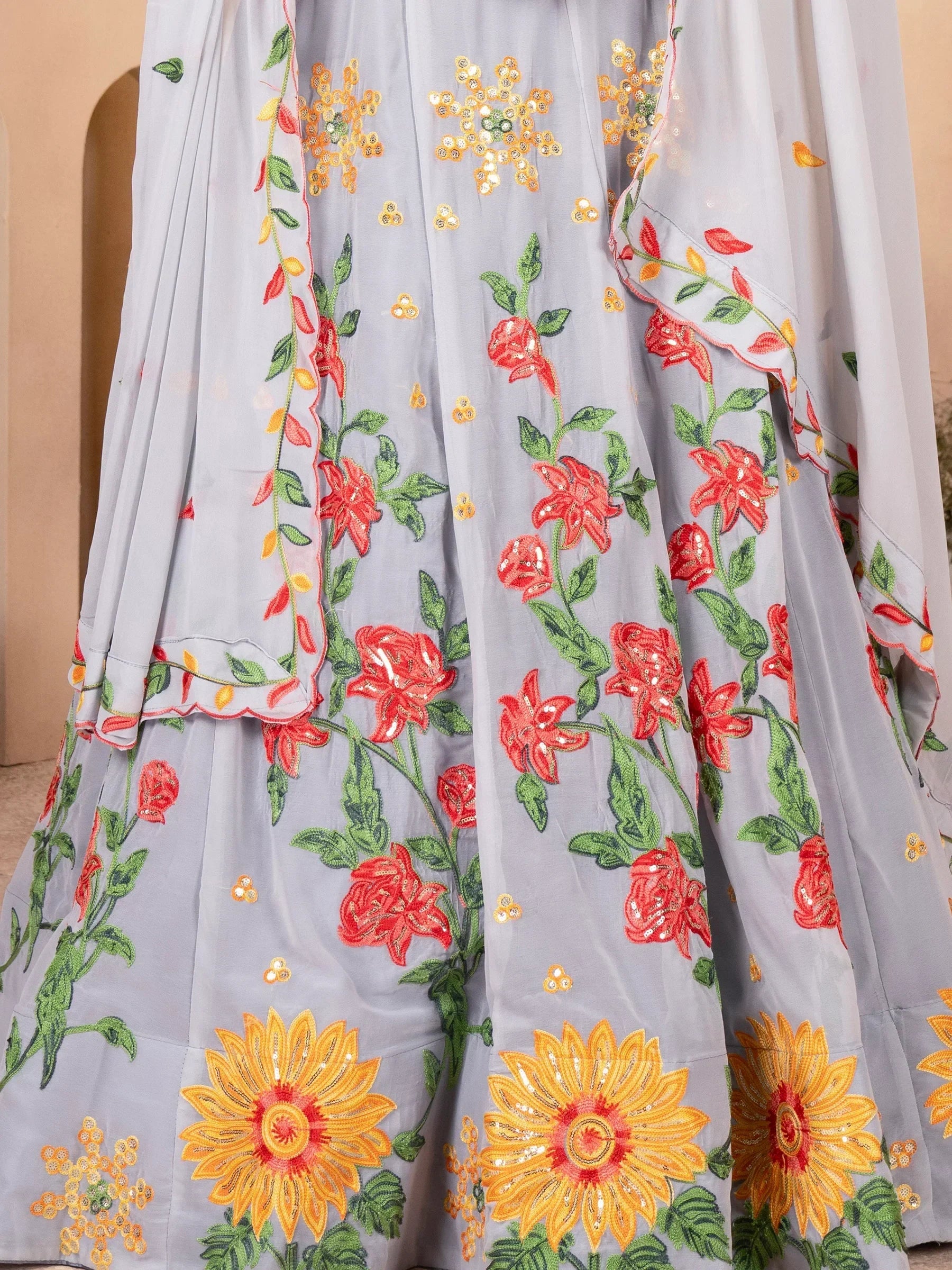 Grey floral embroidered lehenga with red roses, sunflowers, and green leaves for Indian ethnic wear