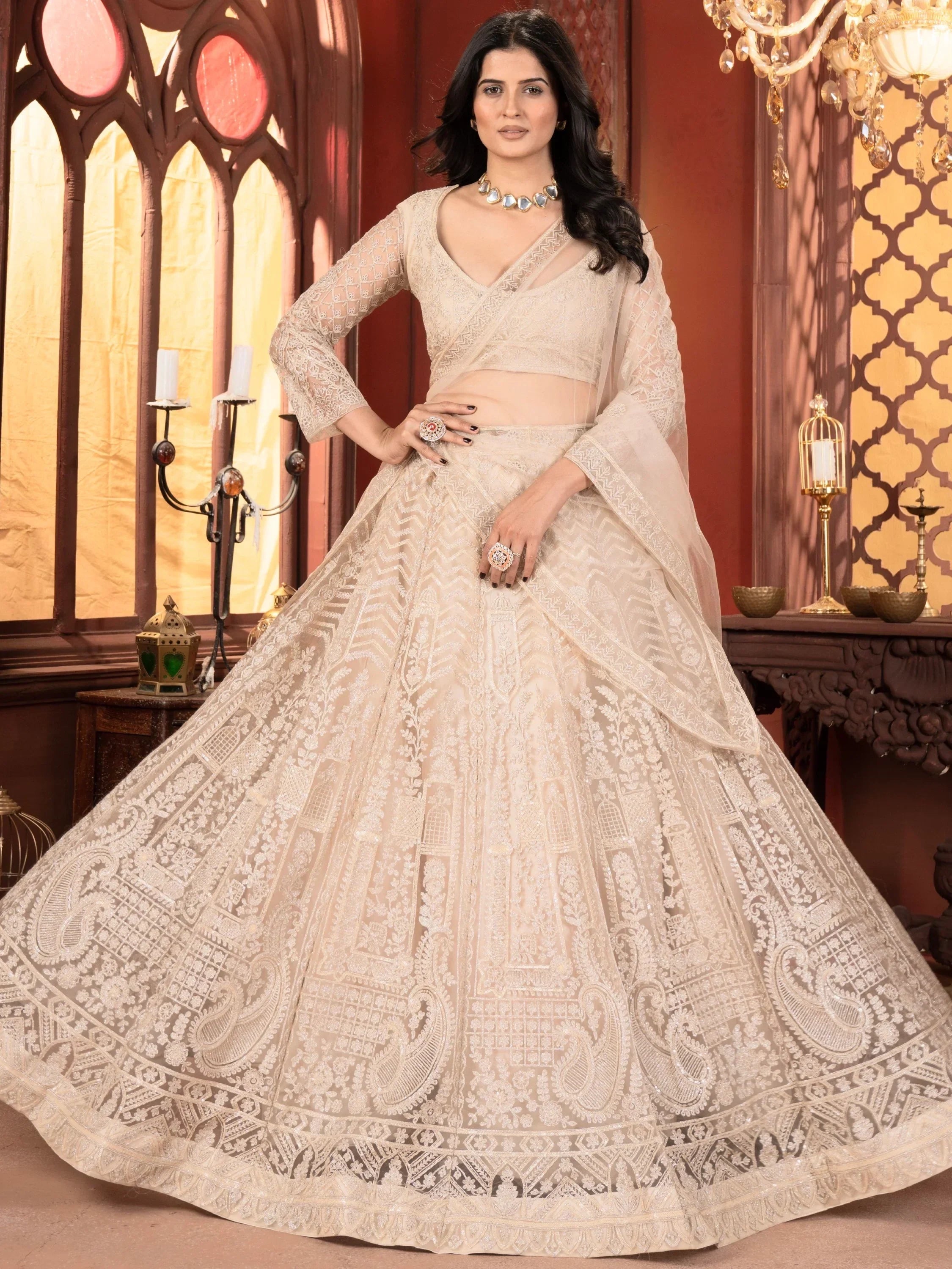 Elegant beige designer lehenga choli with intricate lace and embroidery, perfect for Indian ethnic occasions