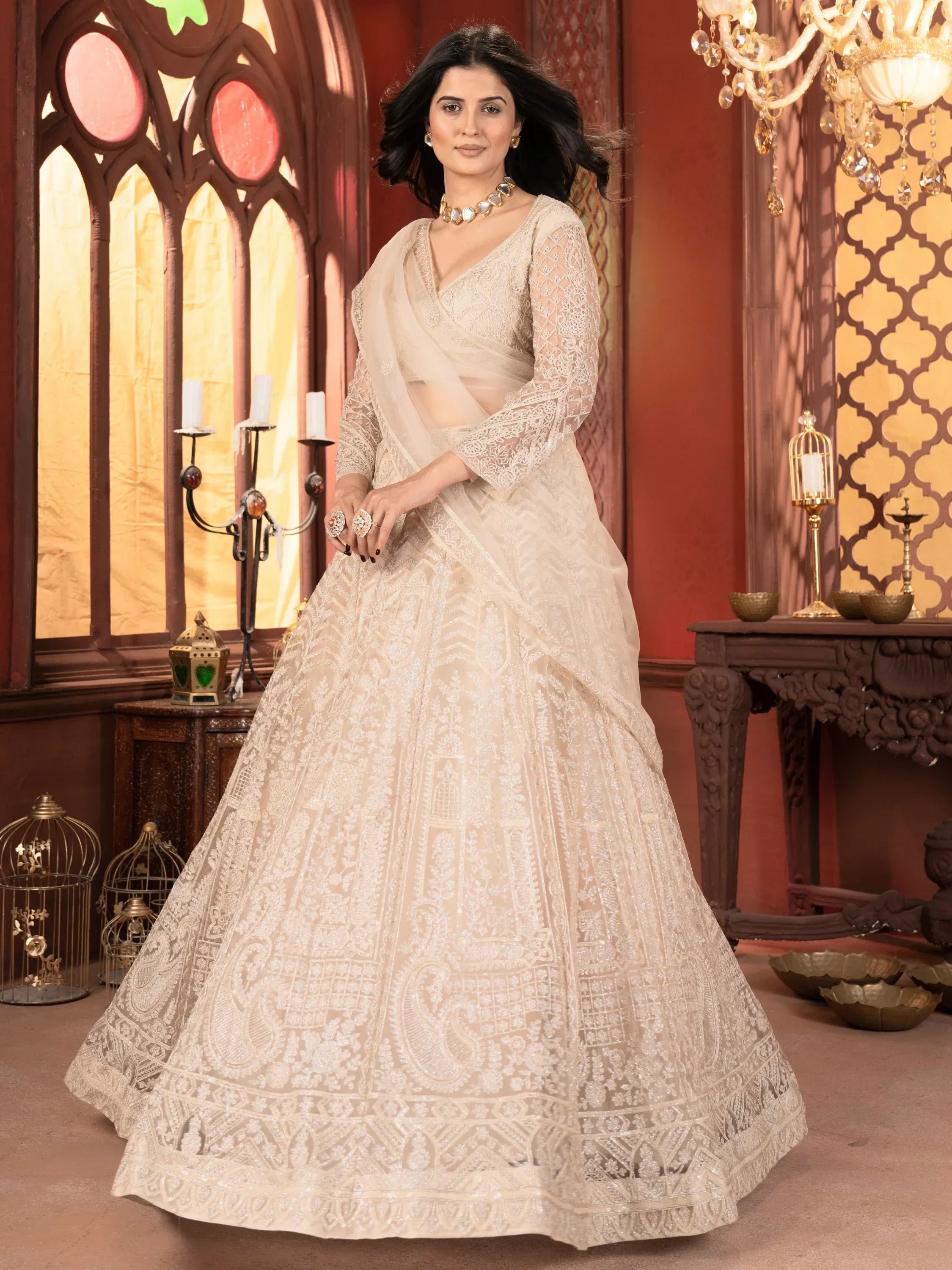Elegant ivory lehenga choli with intricate lace and embroidery, perfect for Indian weddings and festive occasions.