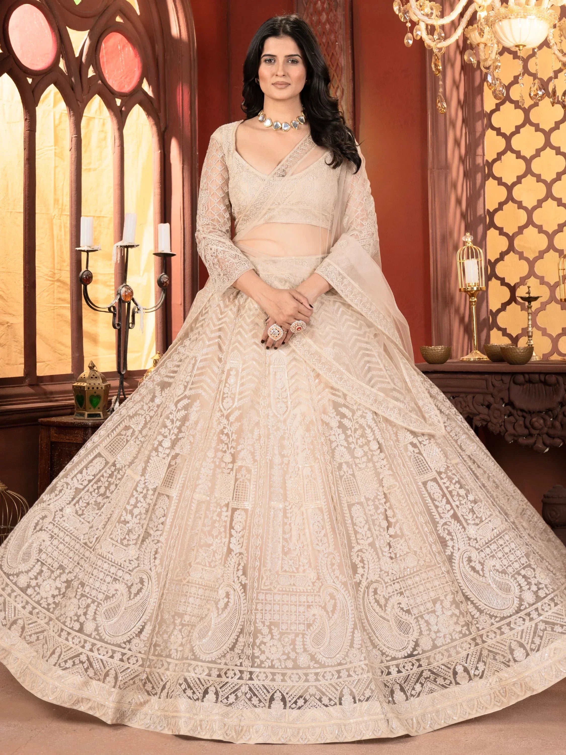Elegant beige designer lehenga choli with intricate embroidery, perfect for Indian weddings and festive occasions.
