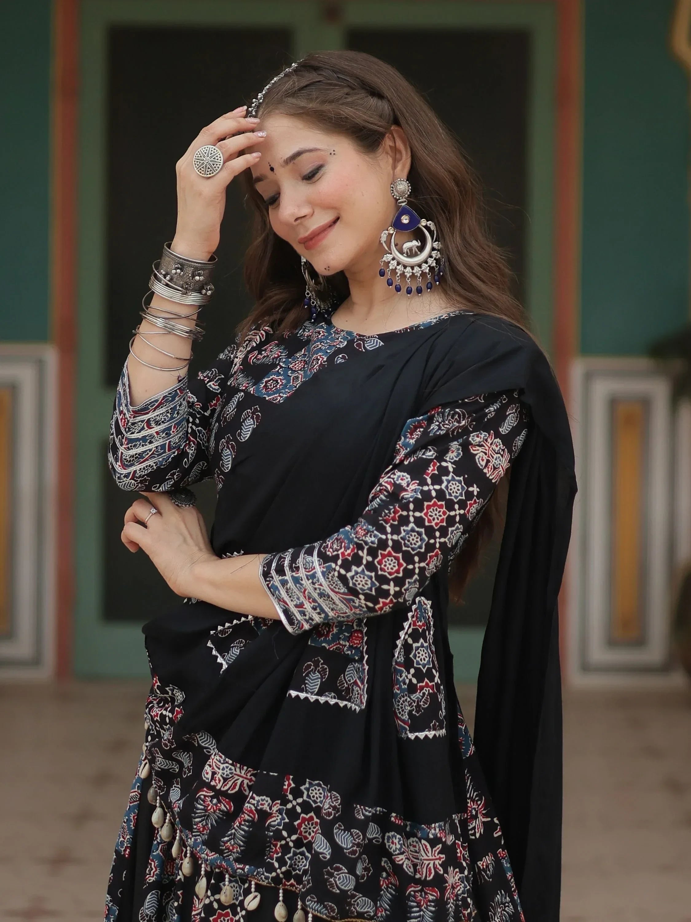 Woman in black printed ethnic salwar kameez with silver jewelry and statement earrings