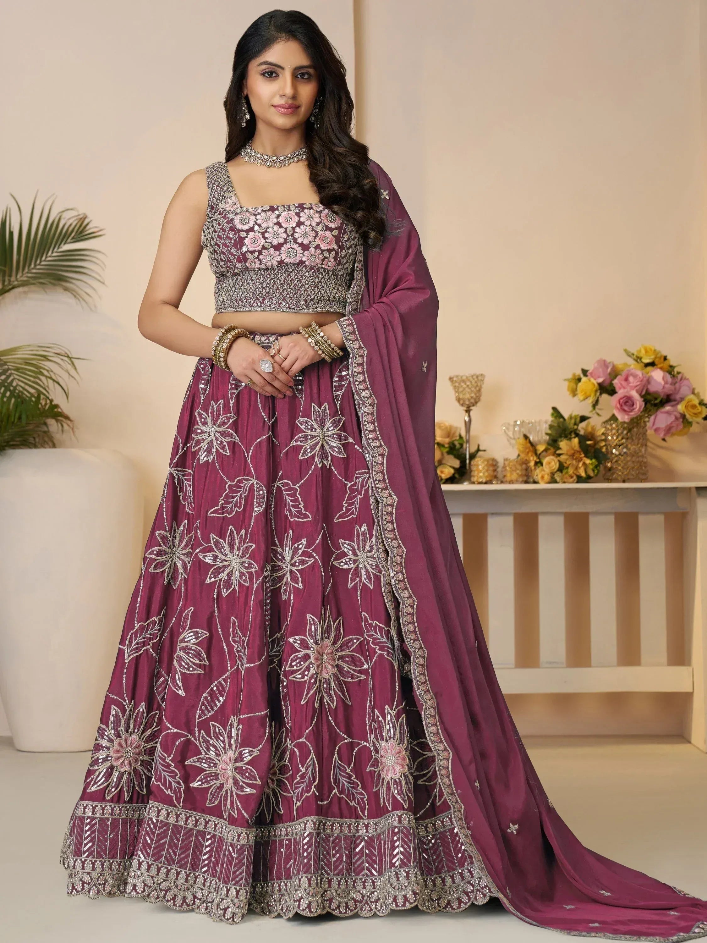 Elegant maroon lehenga choli with floral embroidery, perfect for Indian weddings and festive occasions.