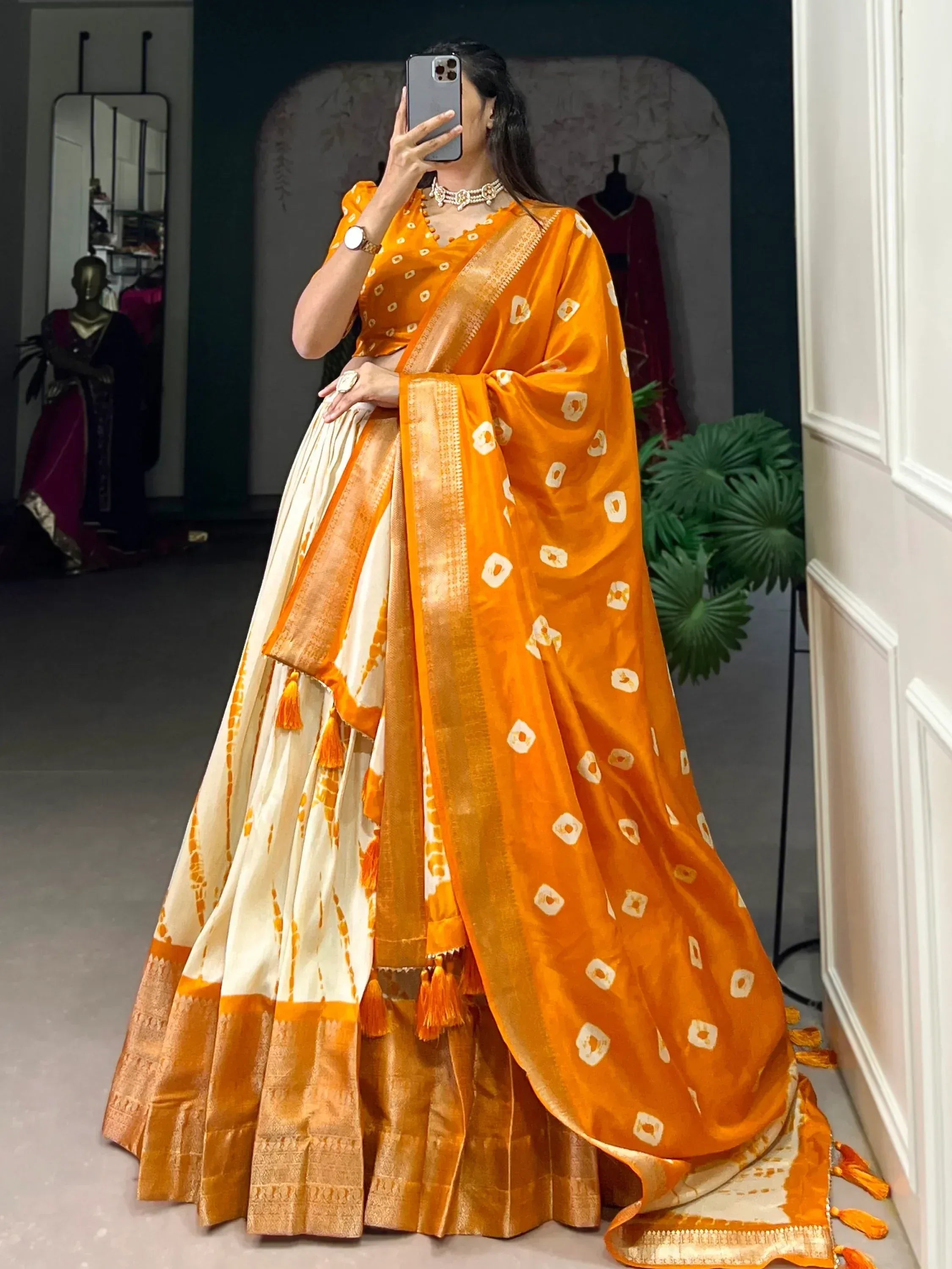 Vibrant orange and cream designer lehenga choli with block print and gold border, perfect for Indian ethnic wear