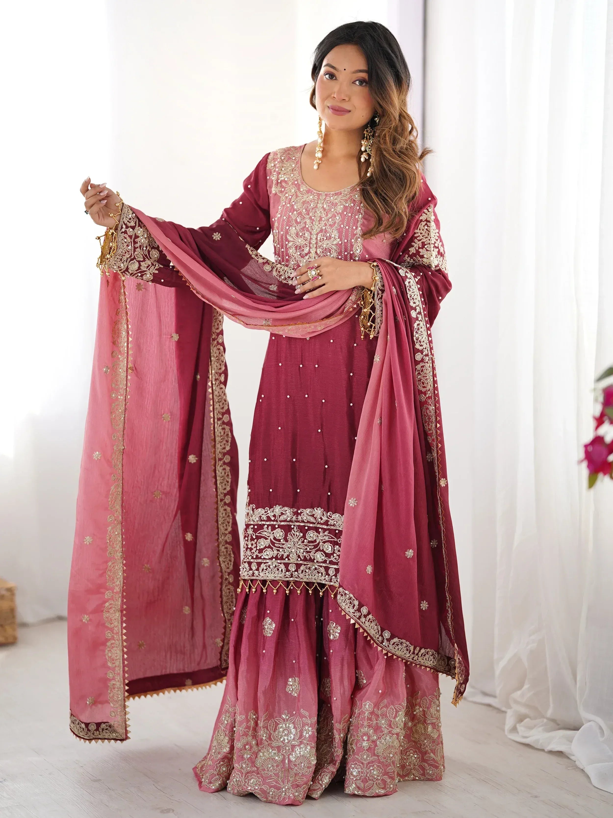 Elegant maroon Indian ethnic wear with gold embroidery, perfect for festive occasions and weddings.