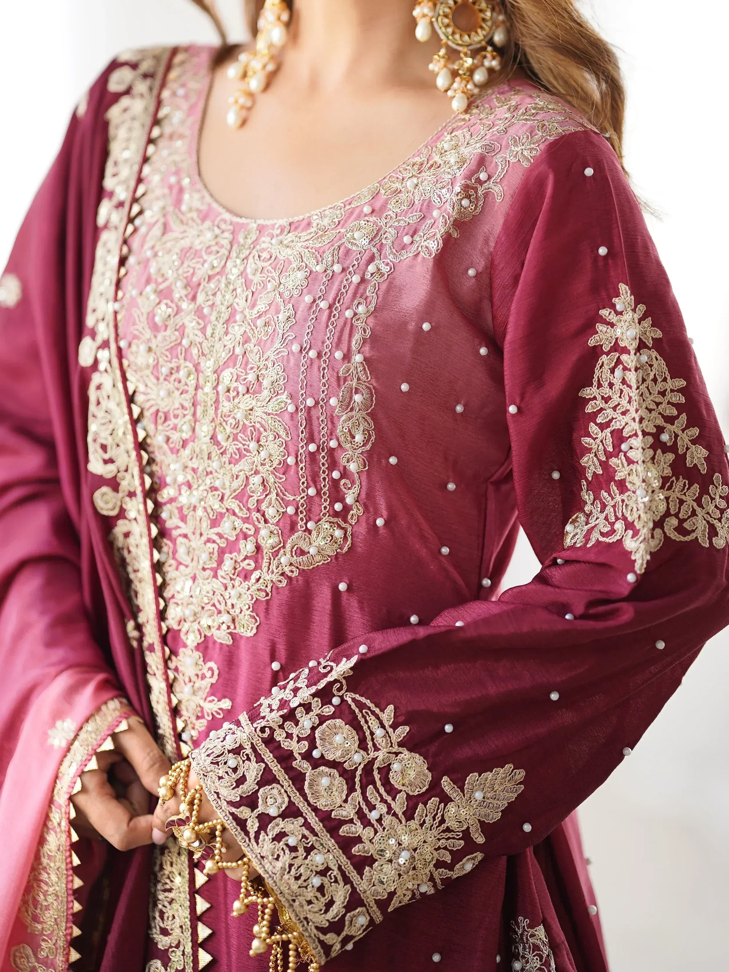 Maroon ethnic salwar kameez with gold embroidery and pearl detailing, perfect for Indian festive occasions