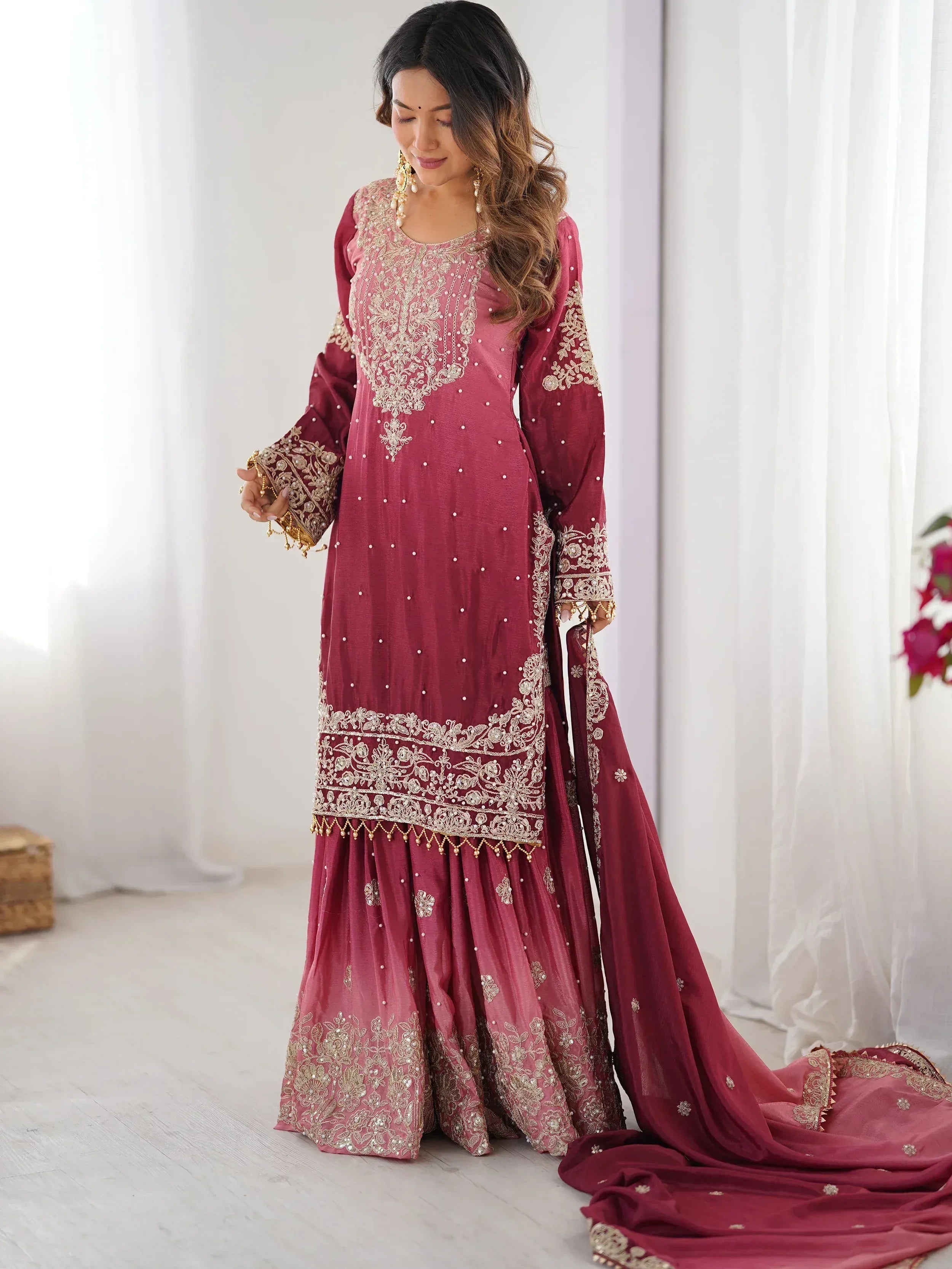 Elegant maroon Indian ethnic wear with gold embroidery, perfect for weddings and festive occasions.