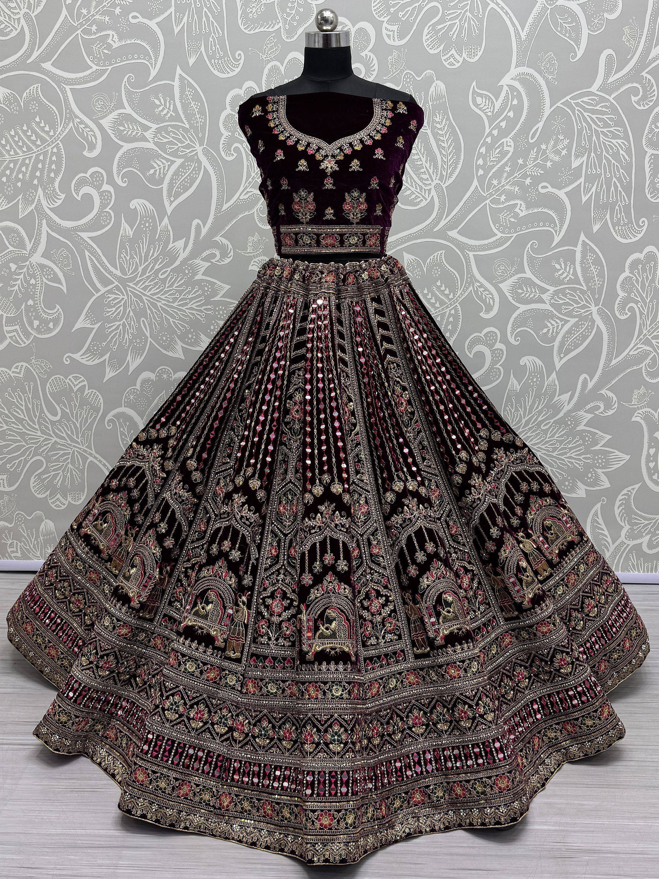 Elegant purple velvet lehenga choli with intricate gold and mirror work, perfect for Indian ethnic occasions.