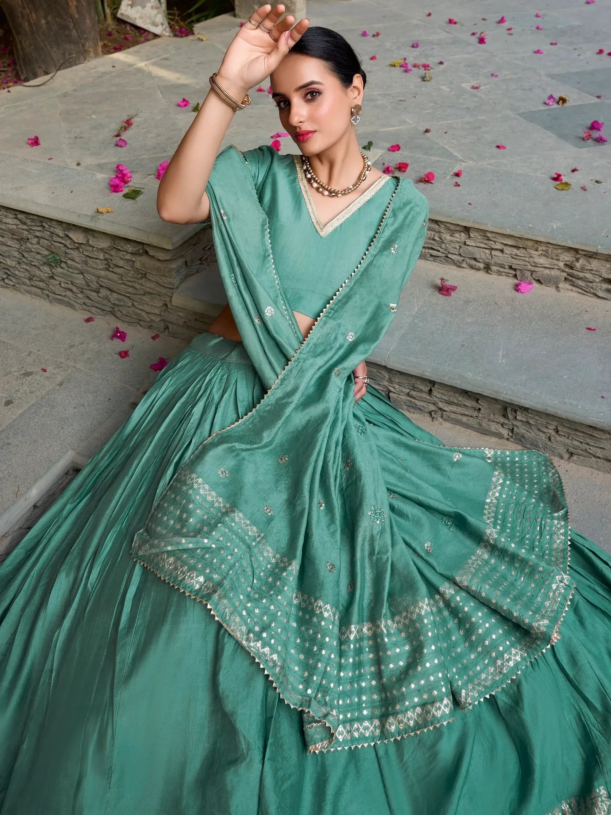 Teal designer lehenga choli with gold embroidery, perfect for Indian ethnic wear and festive occasions.