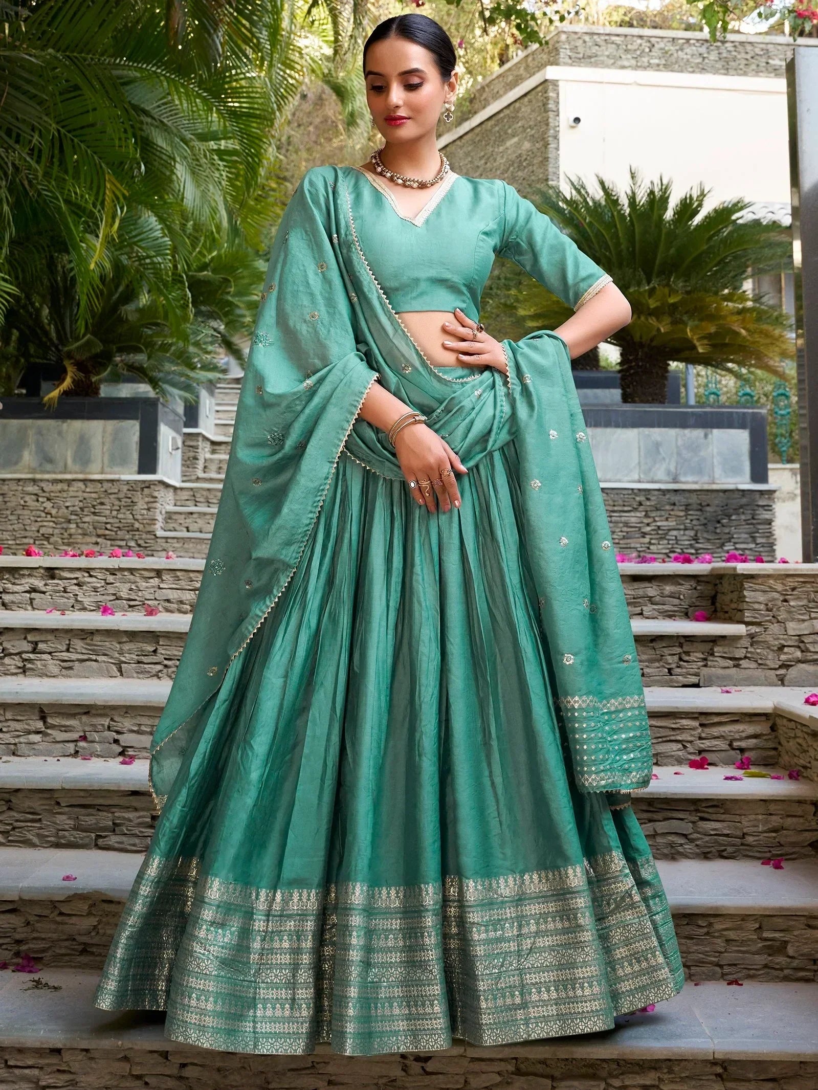 Teal green designer lehenga choli with gold embroidery, perfect for Indian ethnic wear occasions