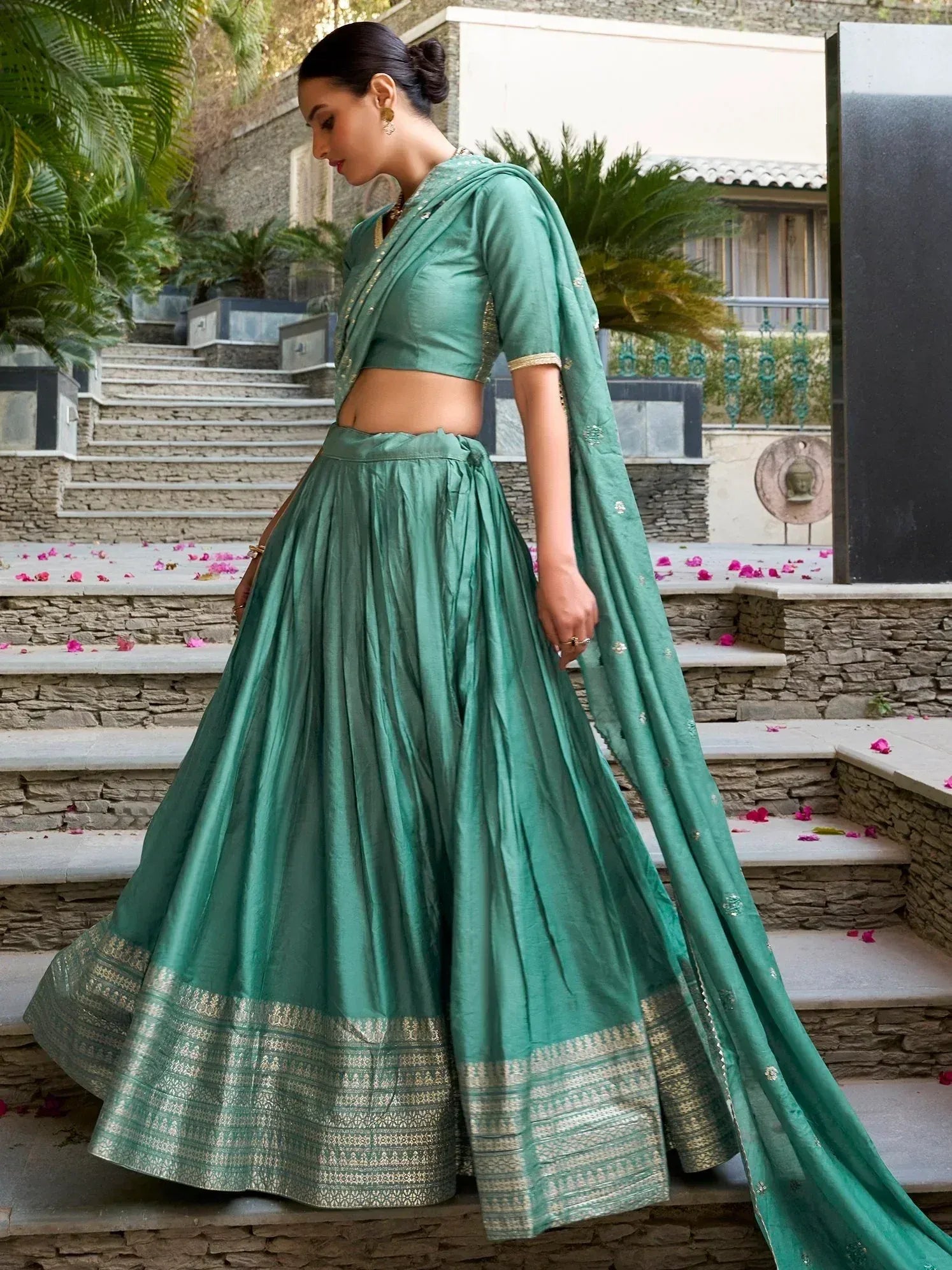 Teal green designer lehenga choli with gold border, perfect for Indian ethnic wear occasions