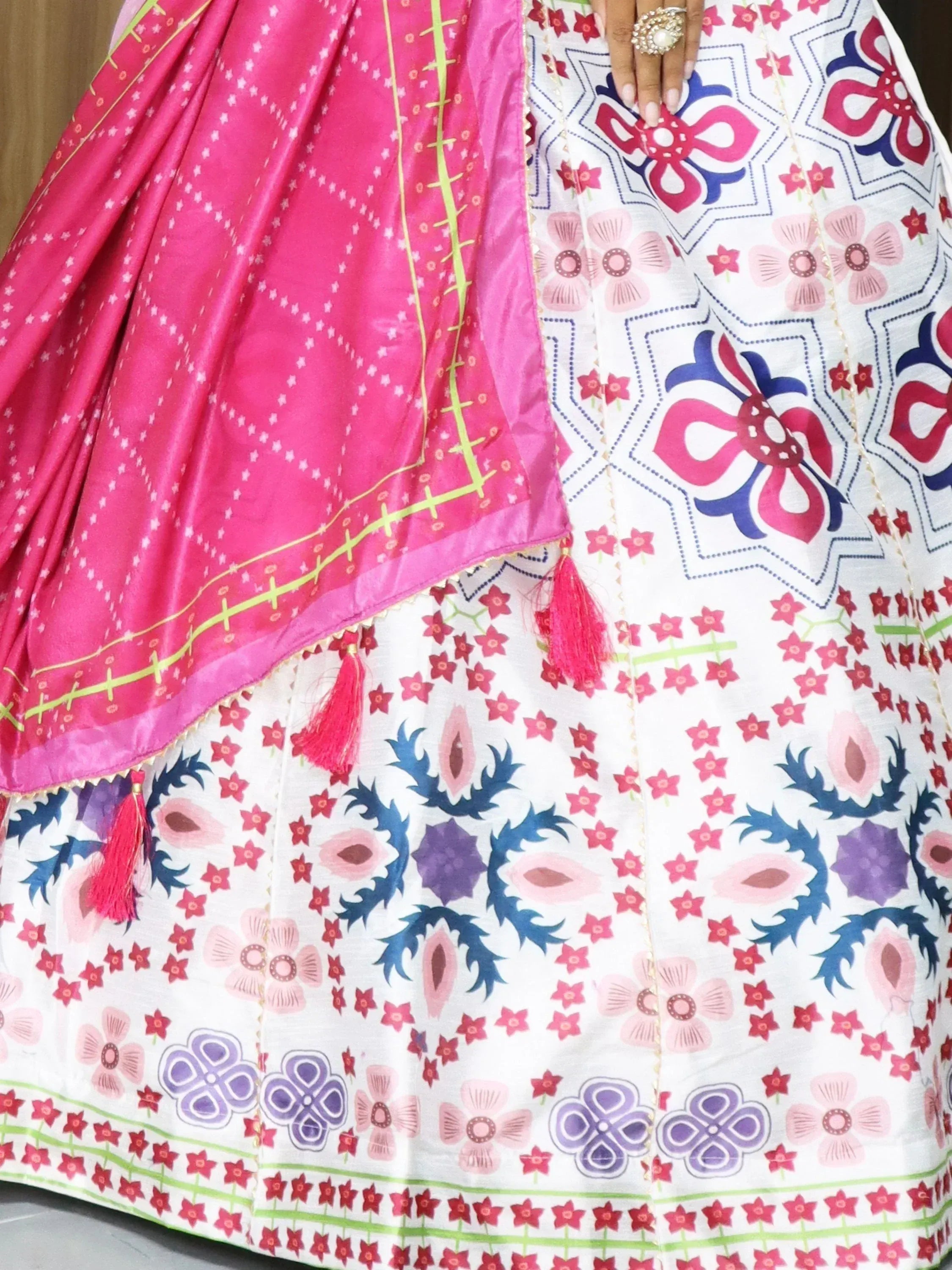 White floral printed lehenga with pink dupatta, ethnic Indian wear, vibrant patterns and tassels