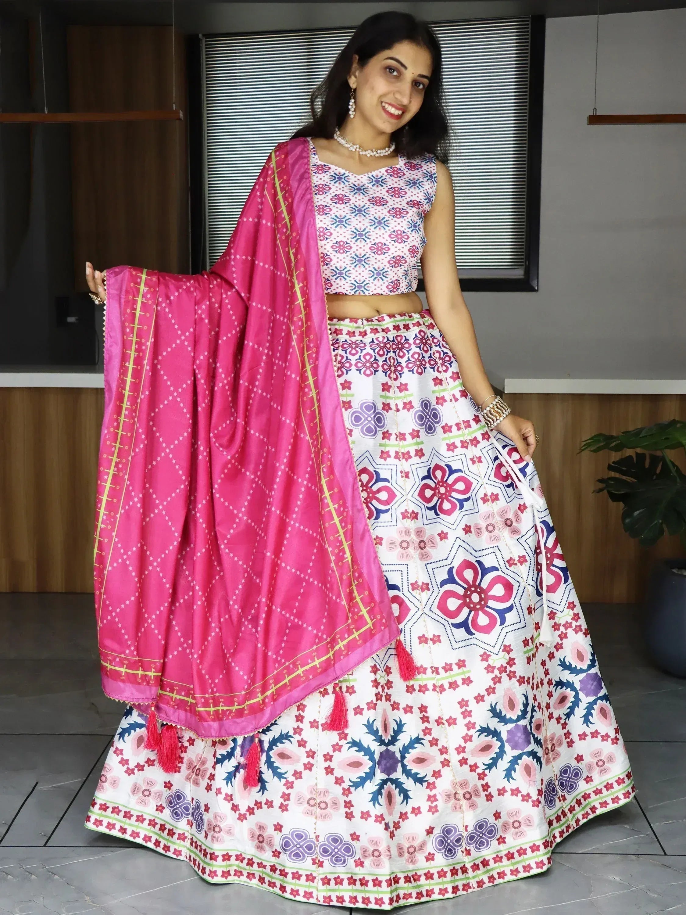 Woman in colorful floral lehenga choli with pink dupatta, Indian ethnic wear for festive occasions