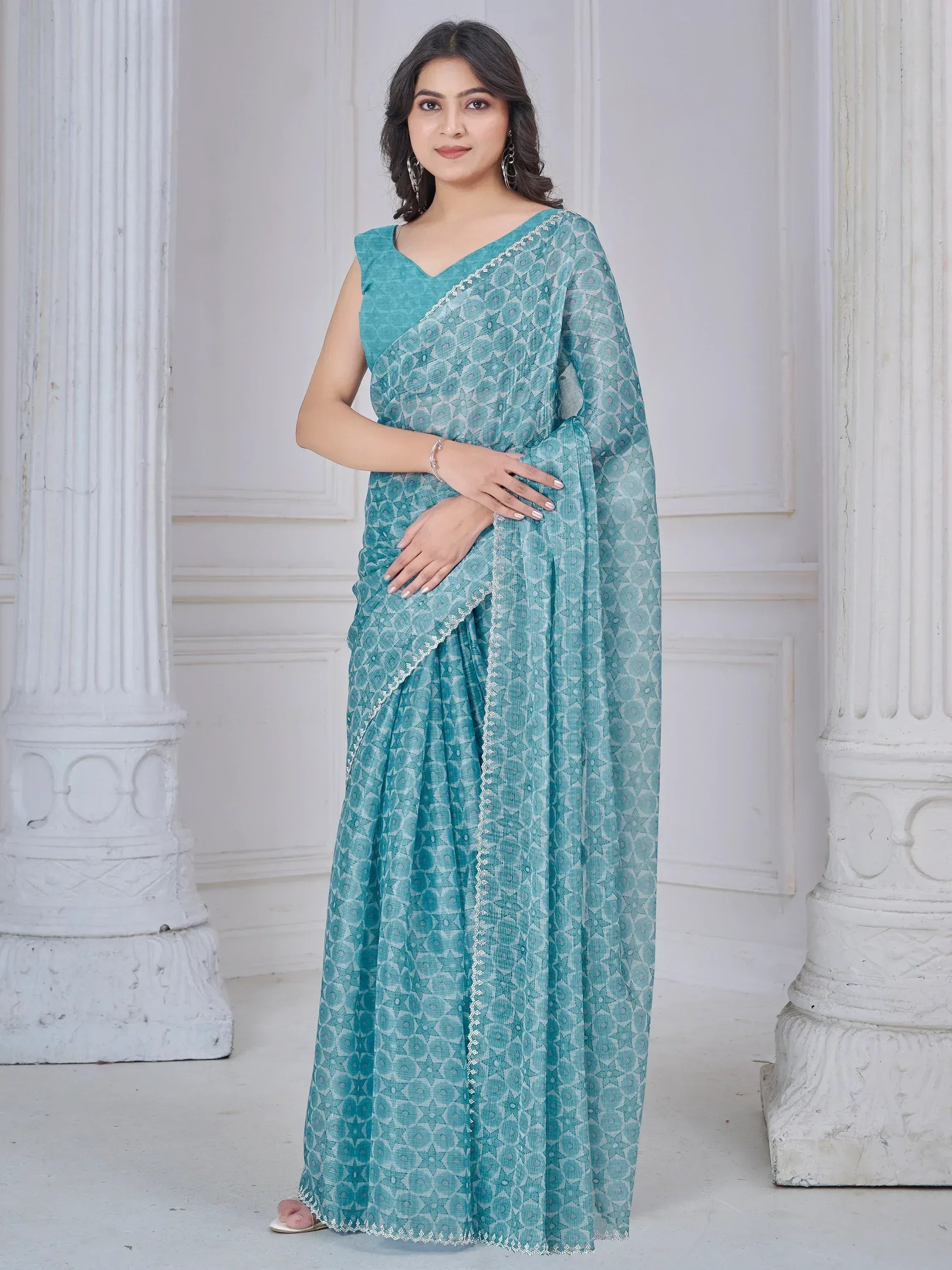 Teal printed saree with white border, perfect for Indian ethnic wear occasions