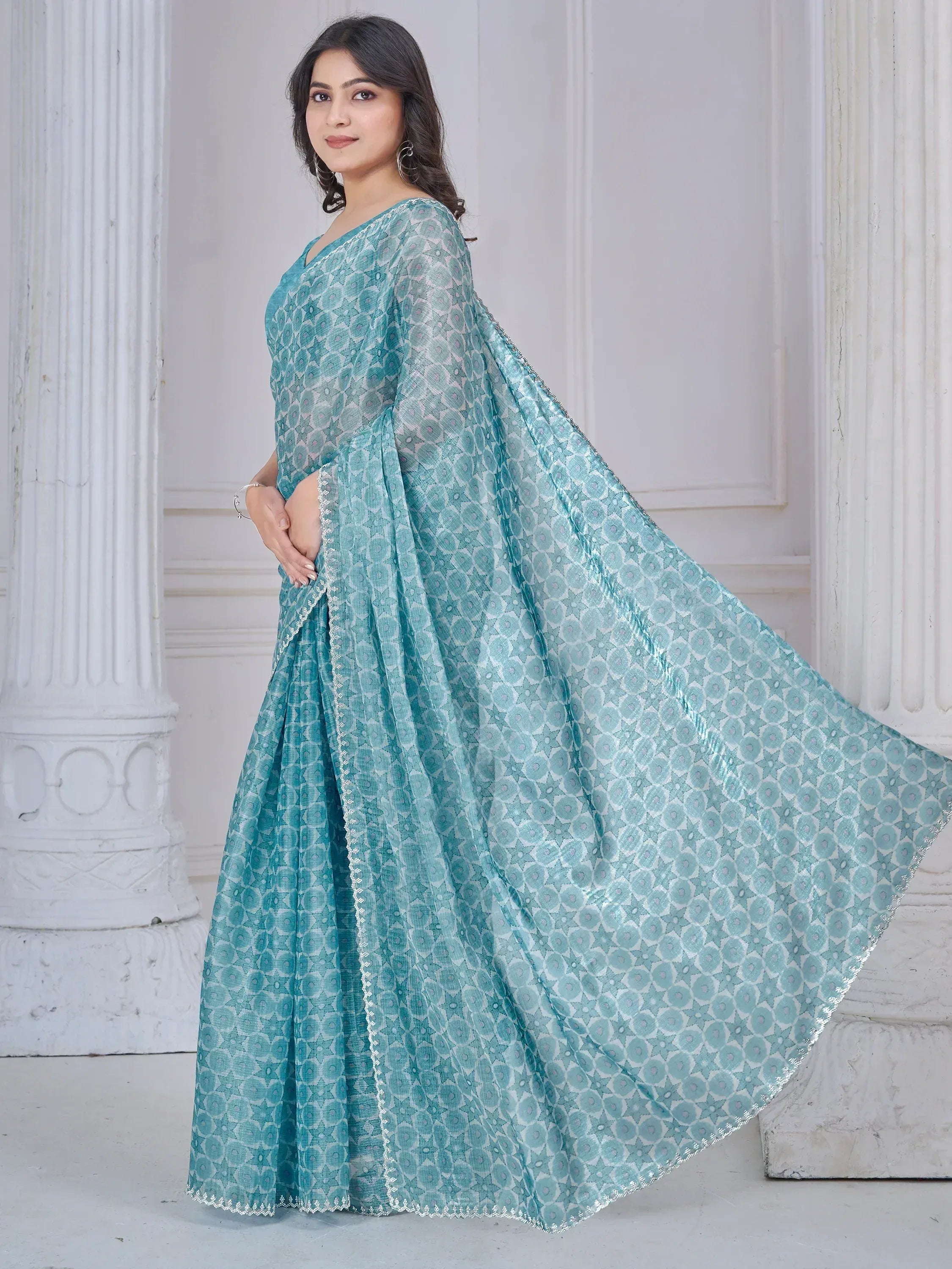 Teal printed saree with geometric pattern and silver border, elegant Indian ethnic wear for women