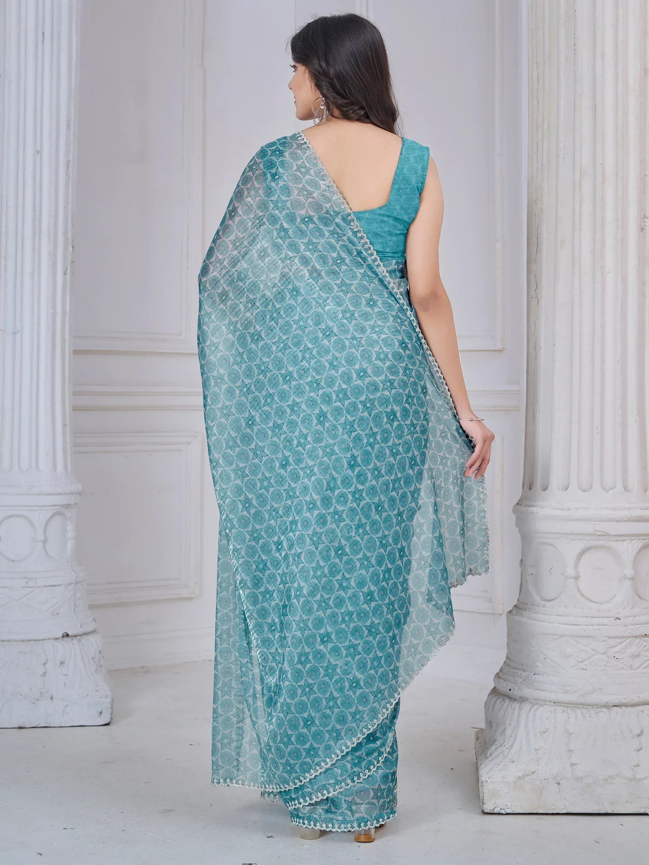 Green and pink designer saree with gold floral motifs and intricate border, paired with matching blouse