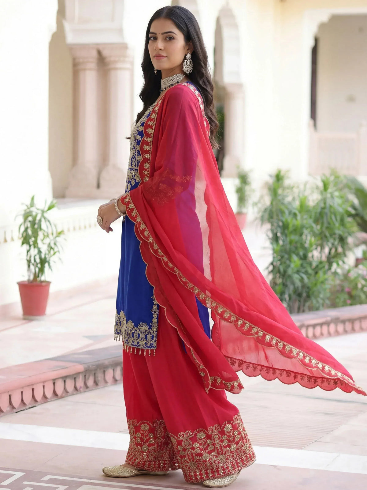 Blue and red embroidered Indian salwar kameez with gold detailing and matching dupatta, perfect for festive occasions.