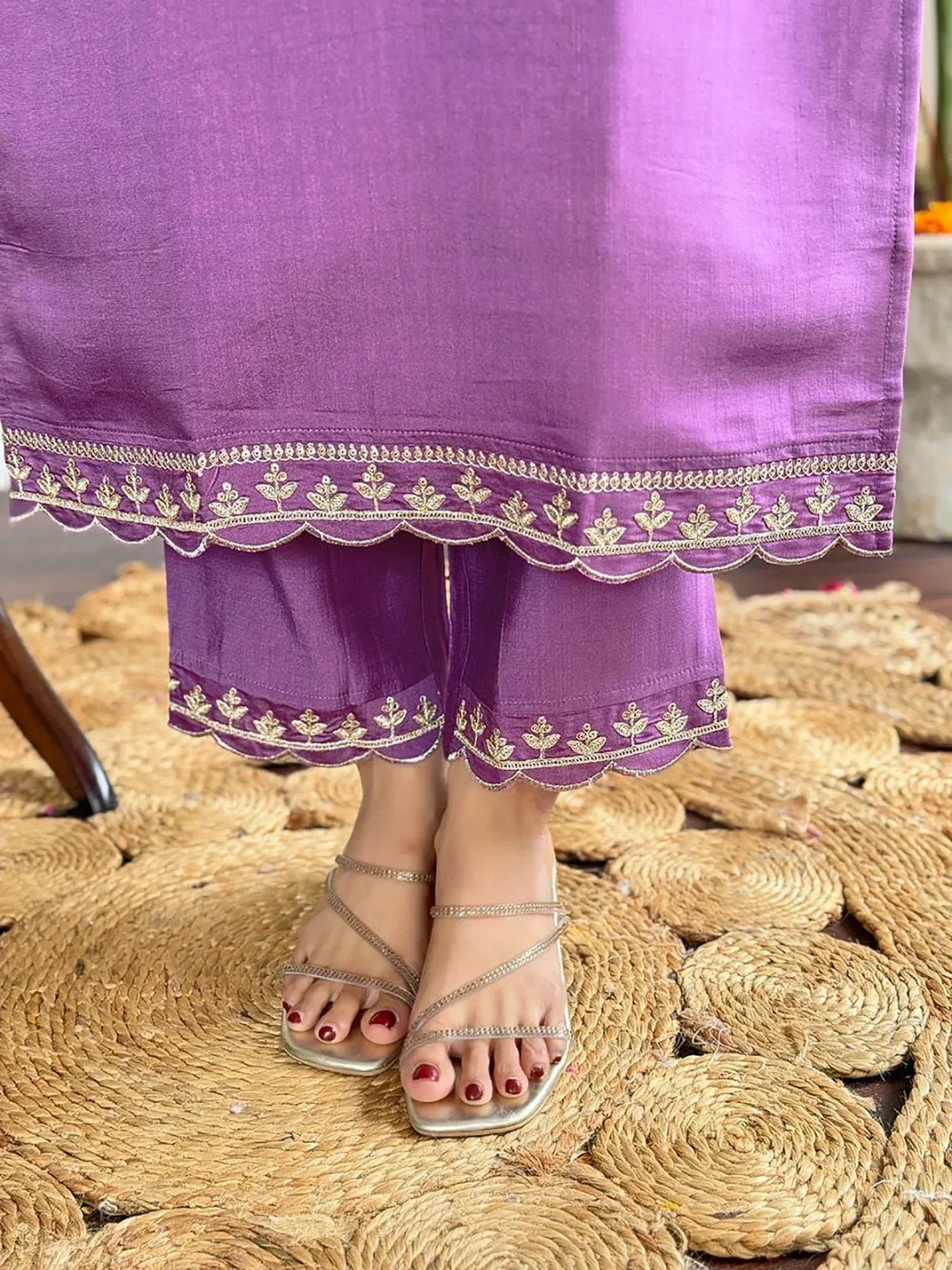 Purple ethnic kurta with gold leaf embroidery and scalloped hem, paired with matching pants and strappy sandals