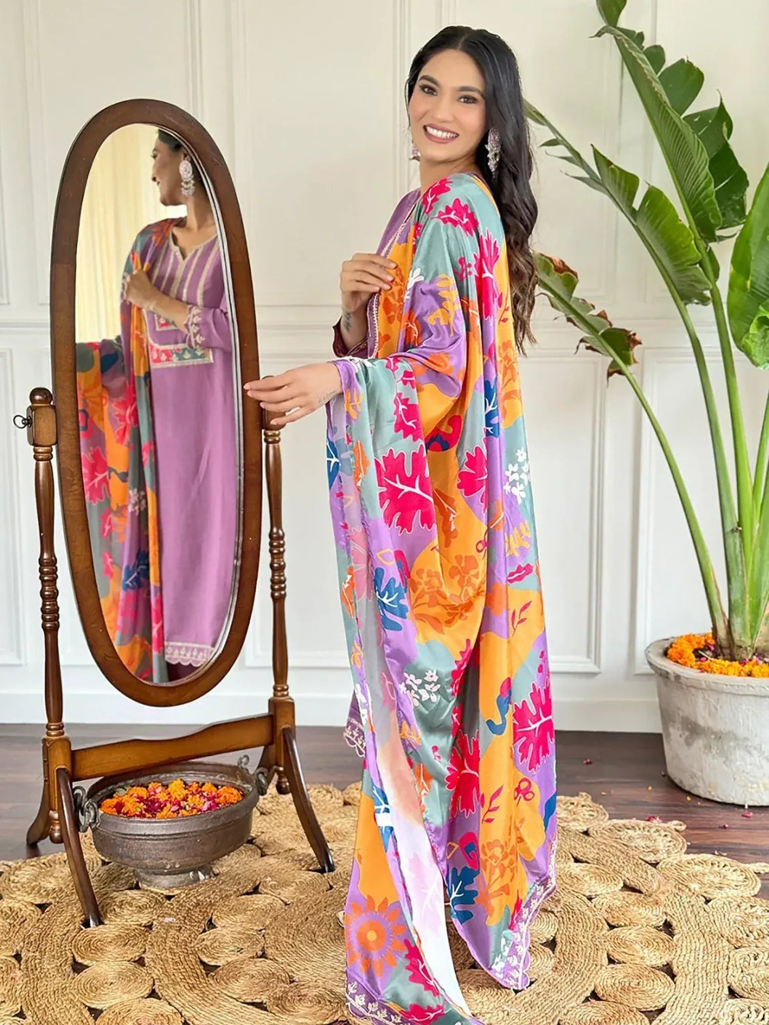 Woman in vibrant floral Indian salwar kameez with mirror reflection, perfect for ethnic occasions