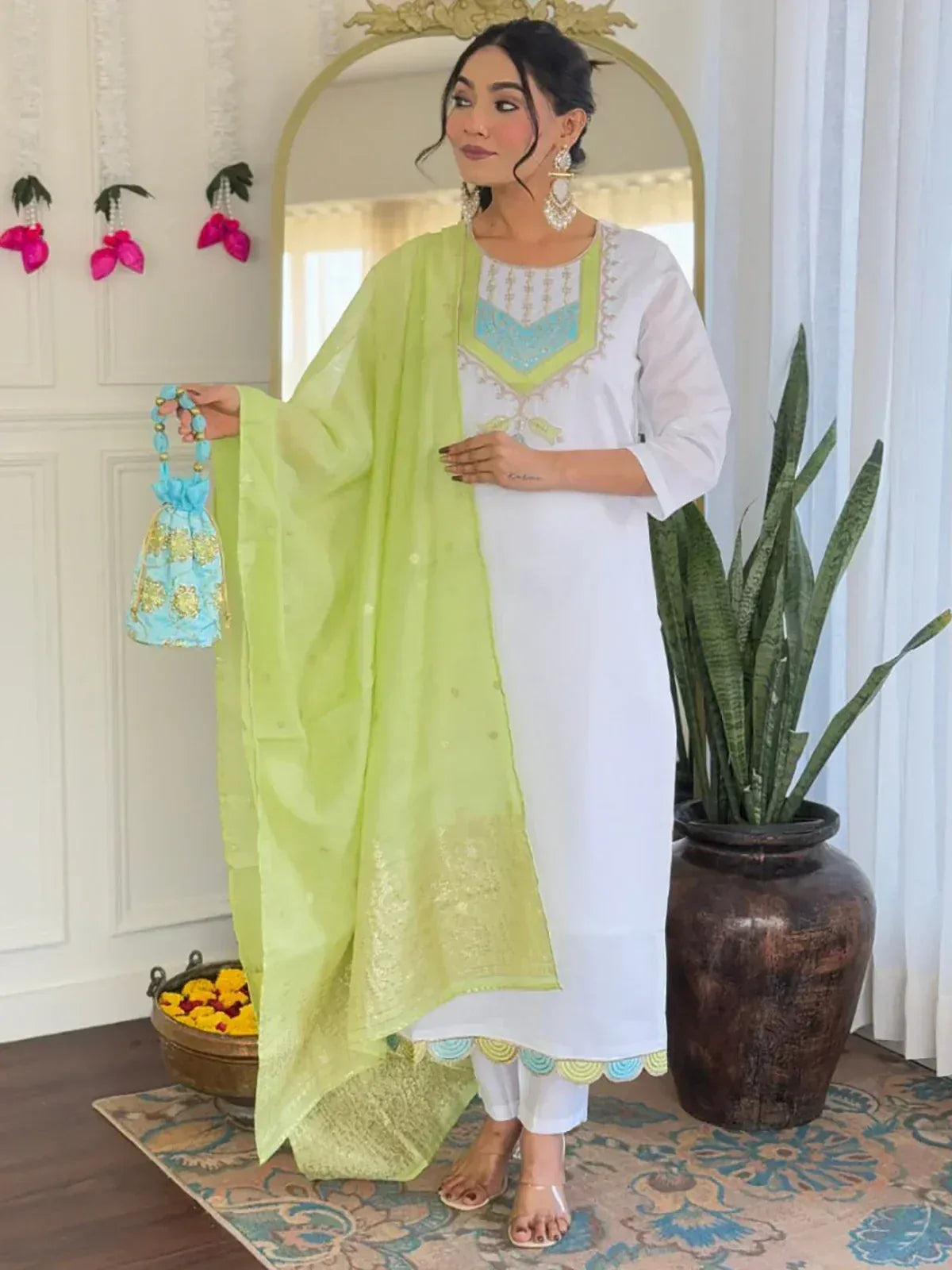 White embroidered kurta with lime green dupatta and matching potli bag, styled for ethnic wear.