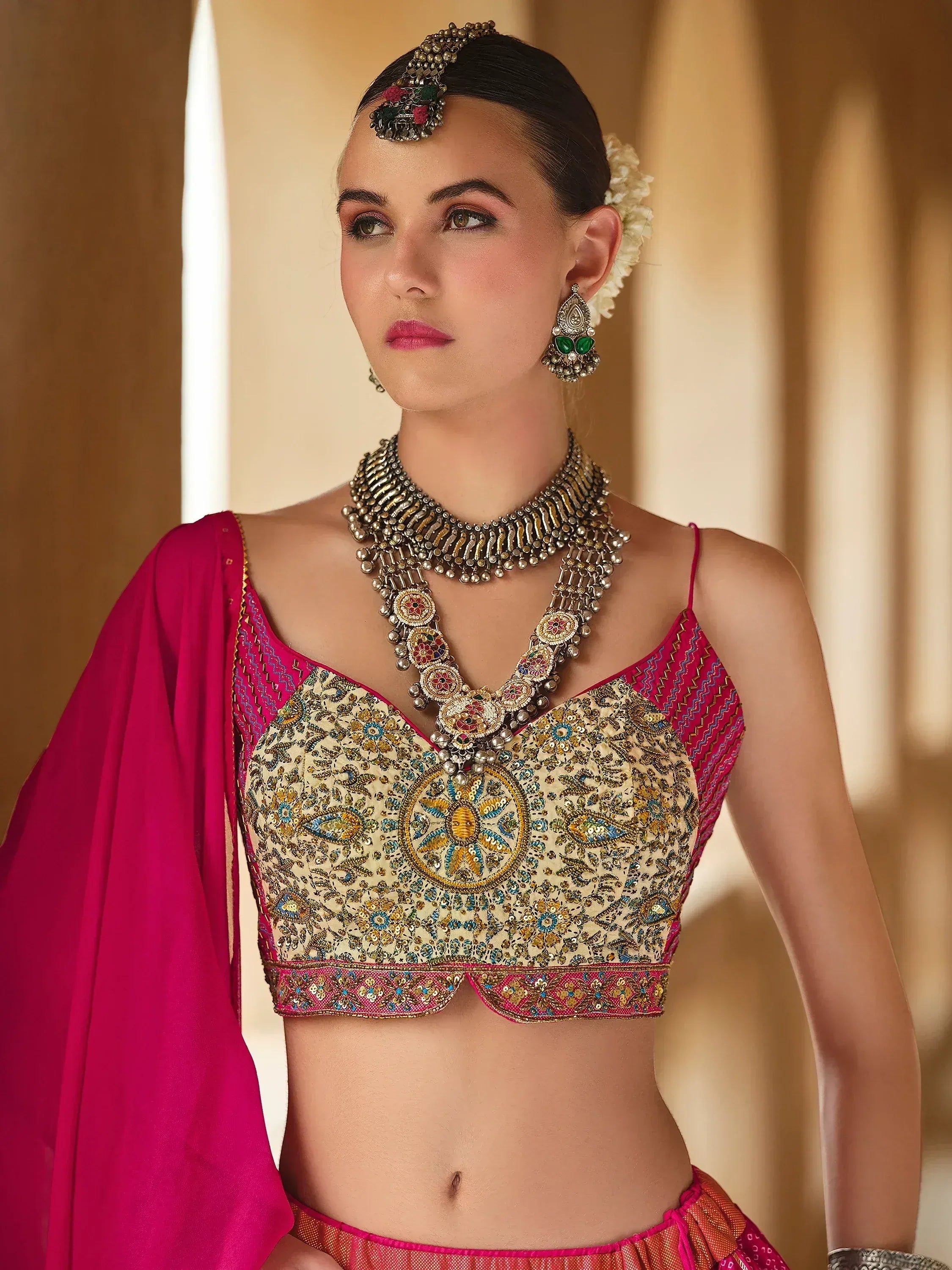Elegant Indian ethnic wear with embroidered blouse, pink dupatta, and traditional jewelry