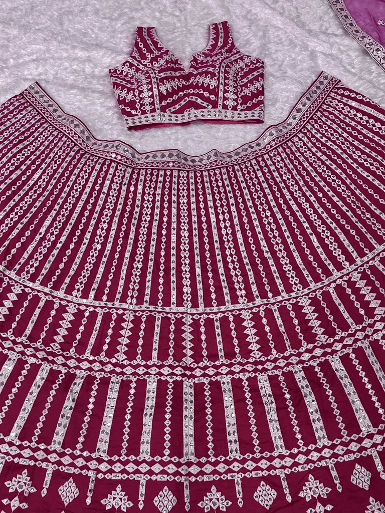 Maroon mirror work lehenga choli with intricate geometric embroidery, perfect for Indian ethnic wear