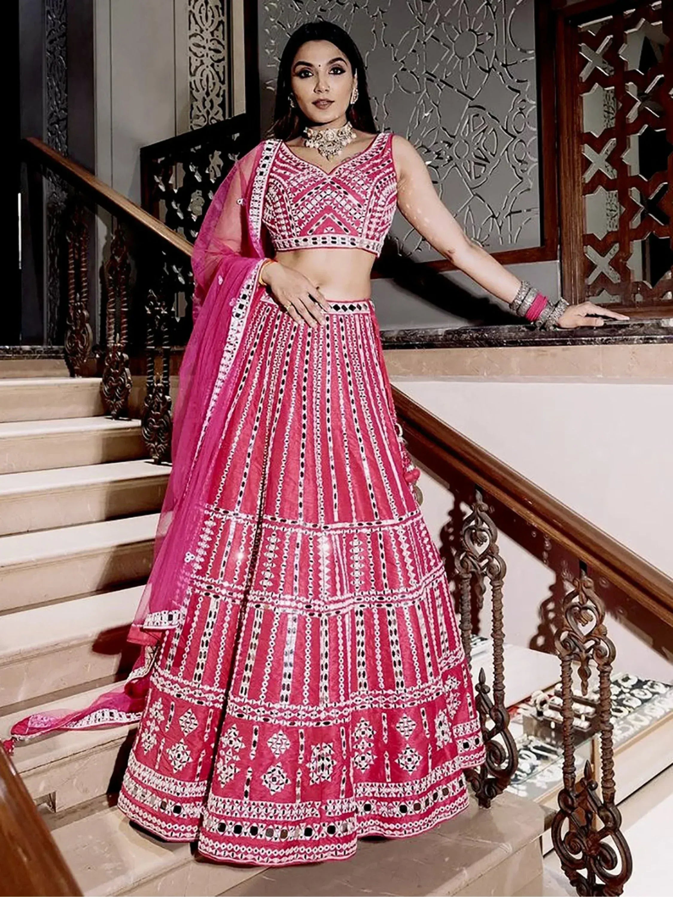 Pink embroidered lehenga choli with mirror work, perfect for Indian weddings and festive occasions