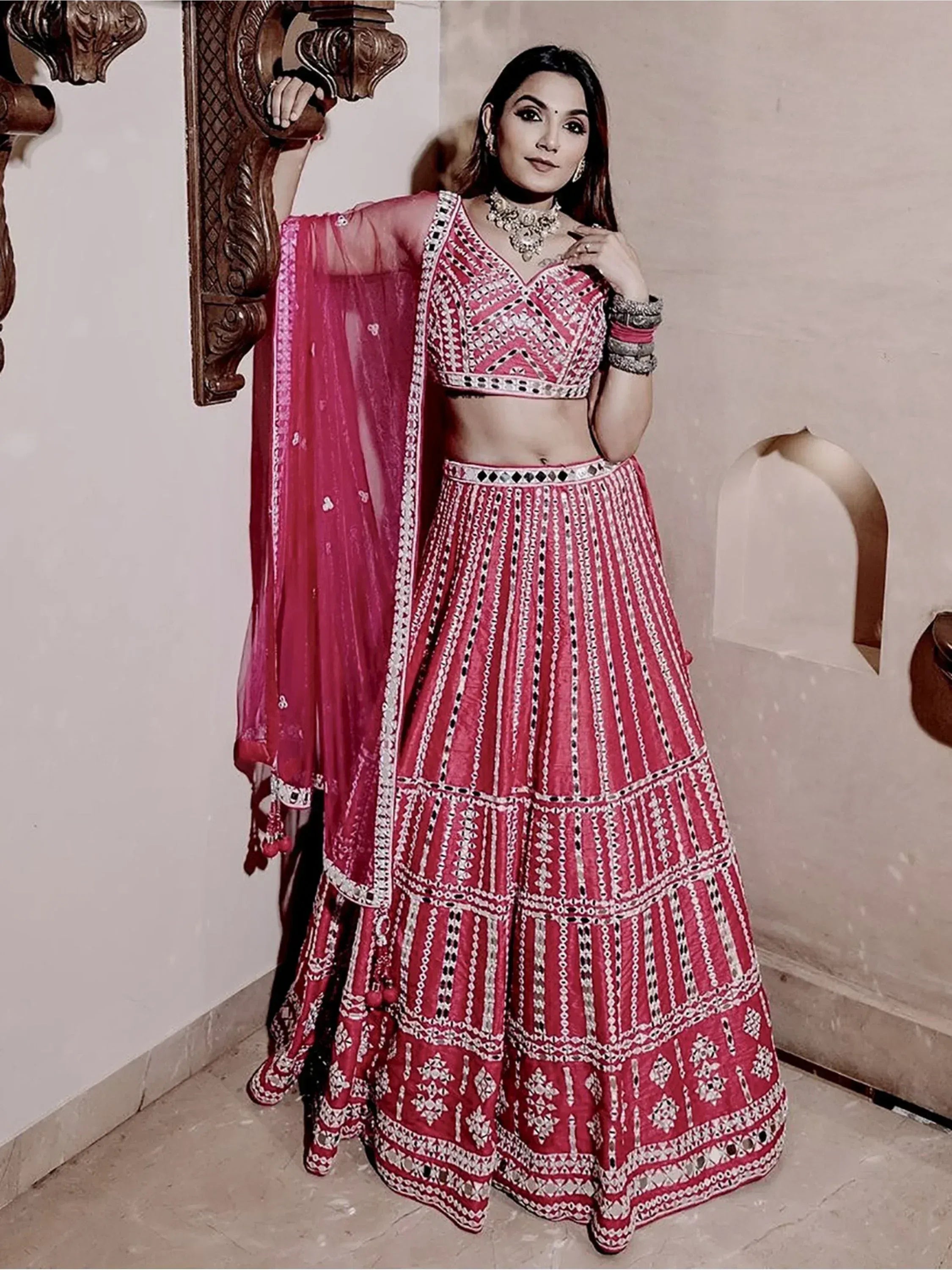 Pink embroidered lehenga choli with mirror work and dupatta, traditional Indian ethnic wear