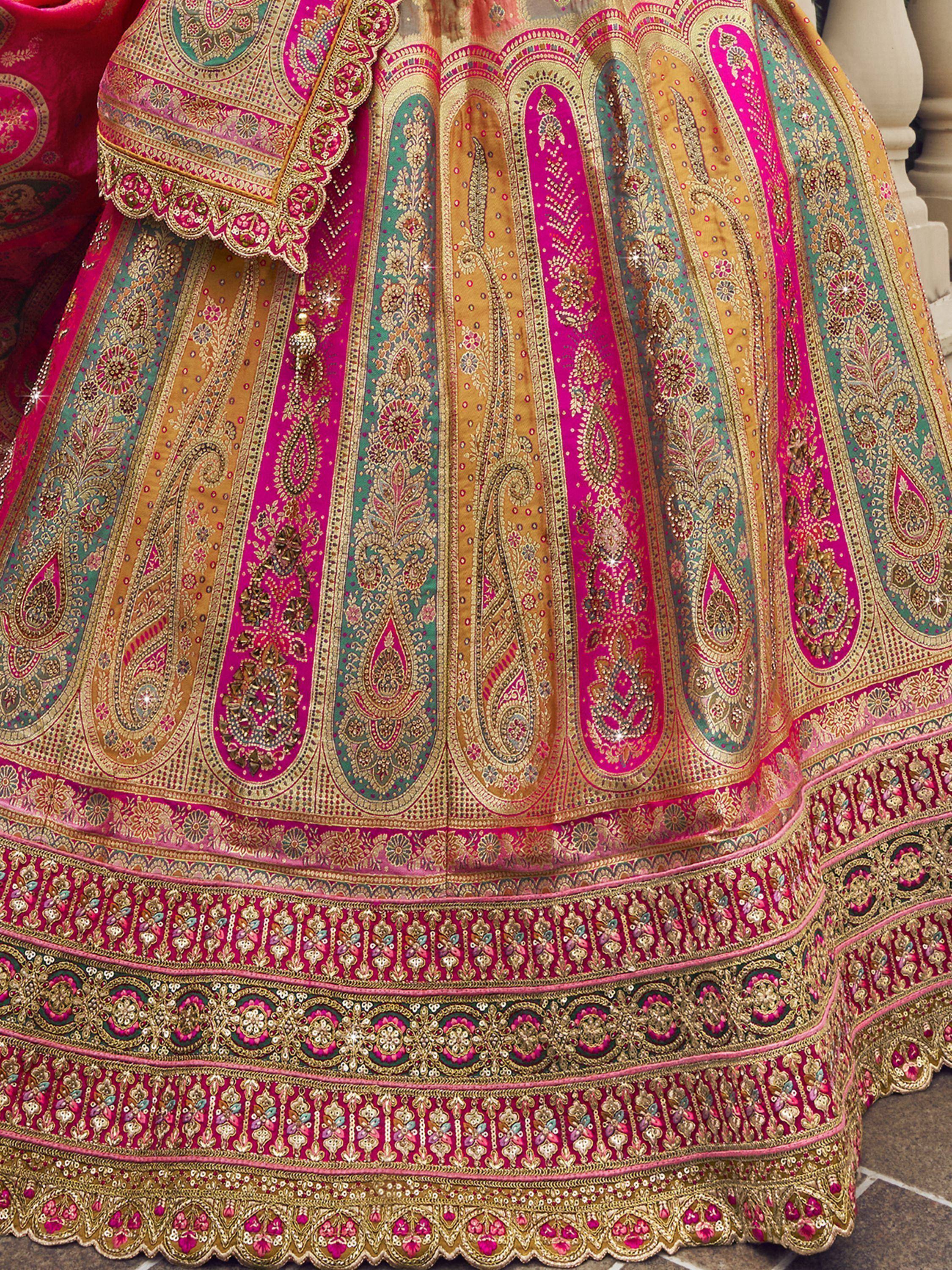 Vibrant pink and gold designer lehenga with intricate paisley embroidery and embellished border