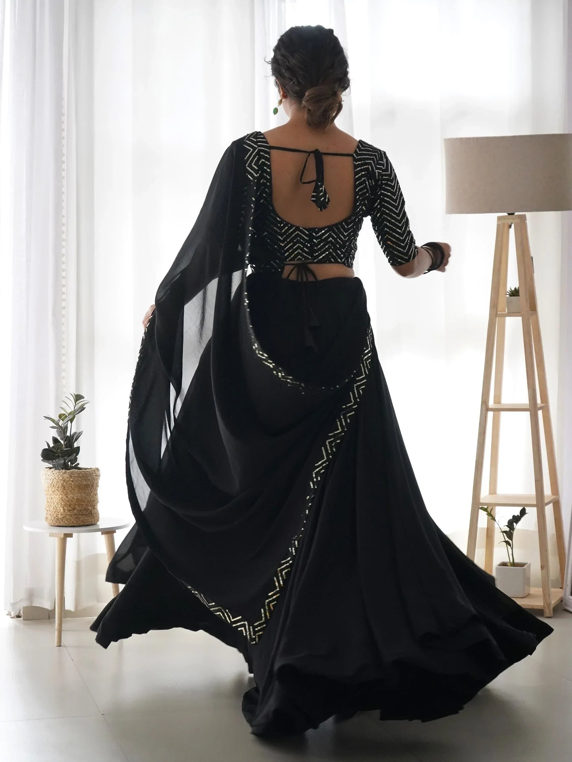 Black designer lehenga choli with geometric sequin work and open back, perfect for ethnic events