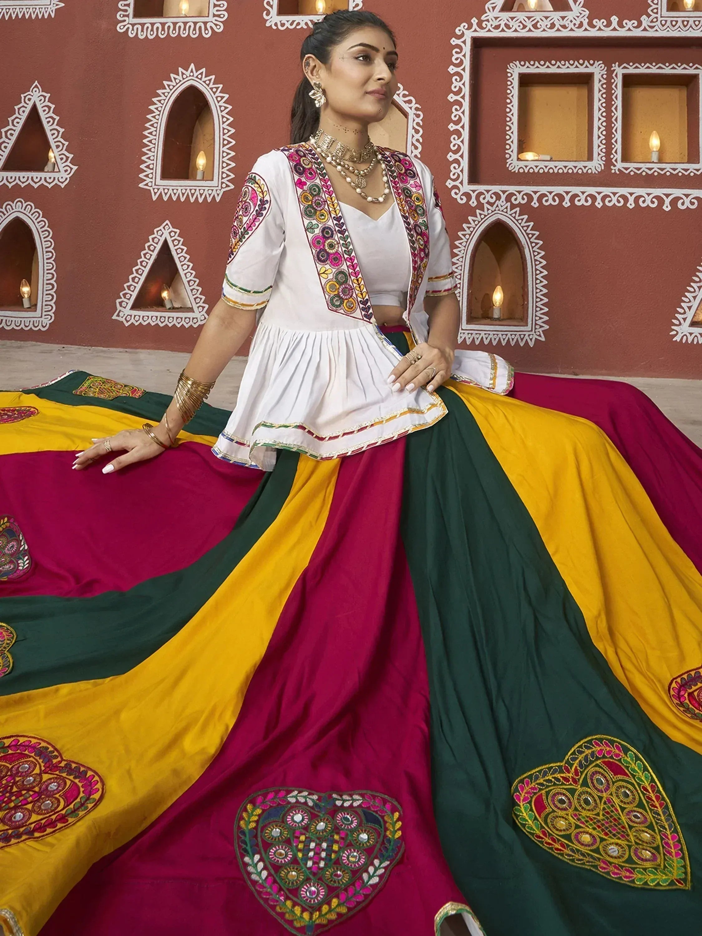 Woman in colorful embroidered lehenga choli with mirror work, traditional Indian ethnic wear