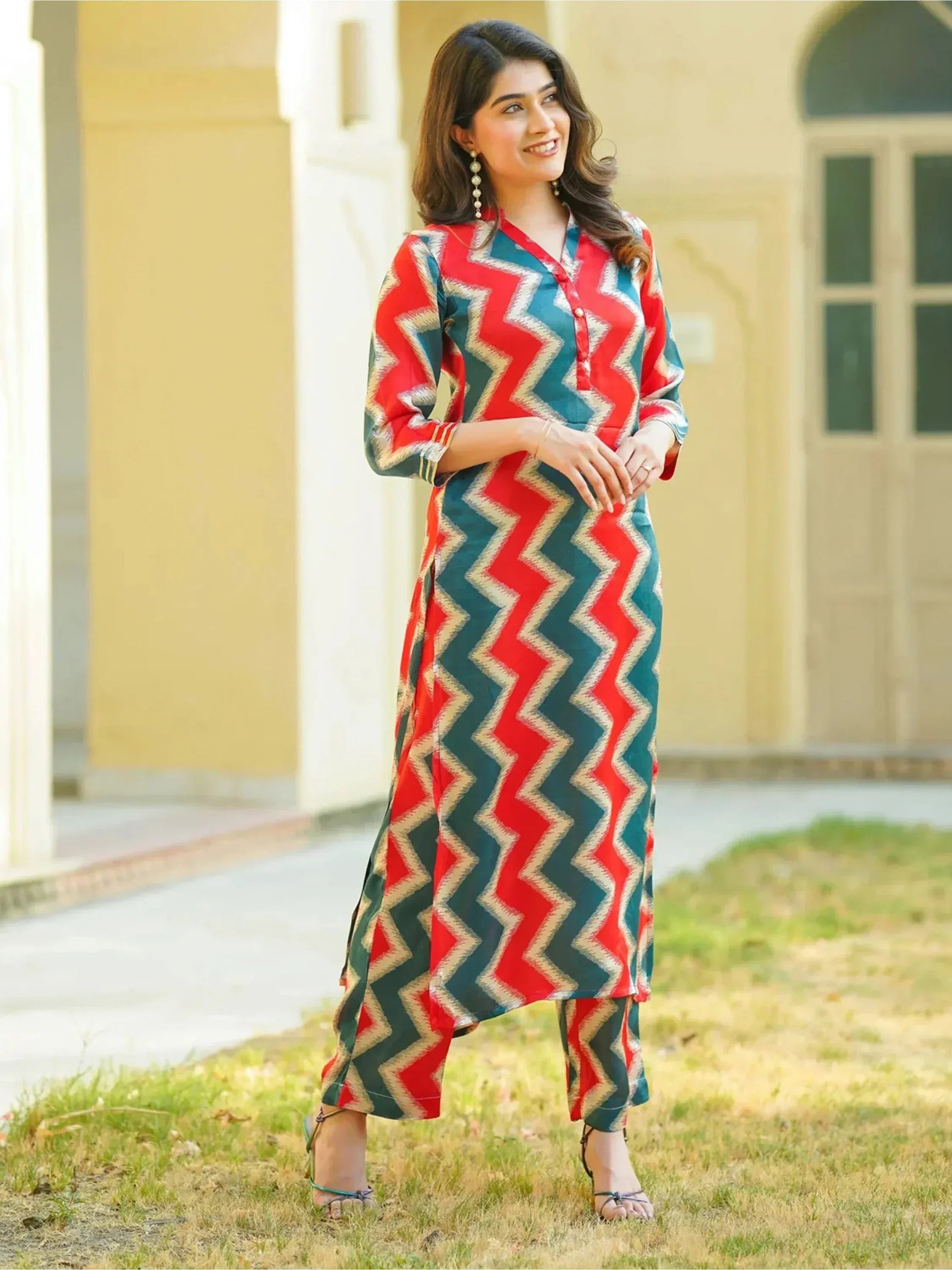Woman in red and teal zigzag print salwar kameez, ethnic Indian wear for festive occasions