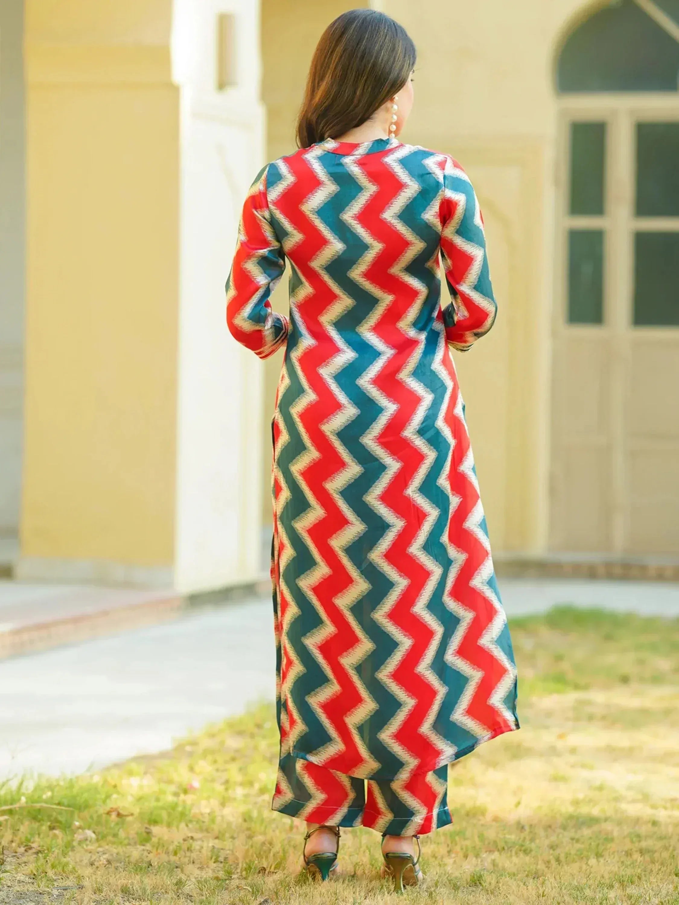 Woman in red and teal zigzag print ethnic kurta with matching palazzo pants, outdoor setting