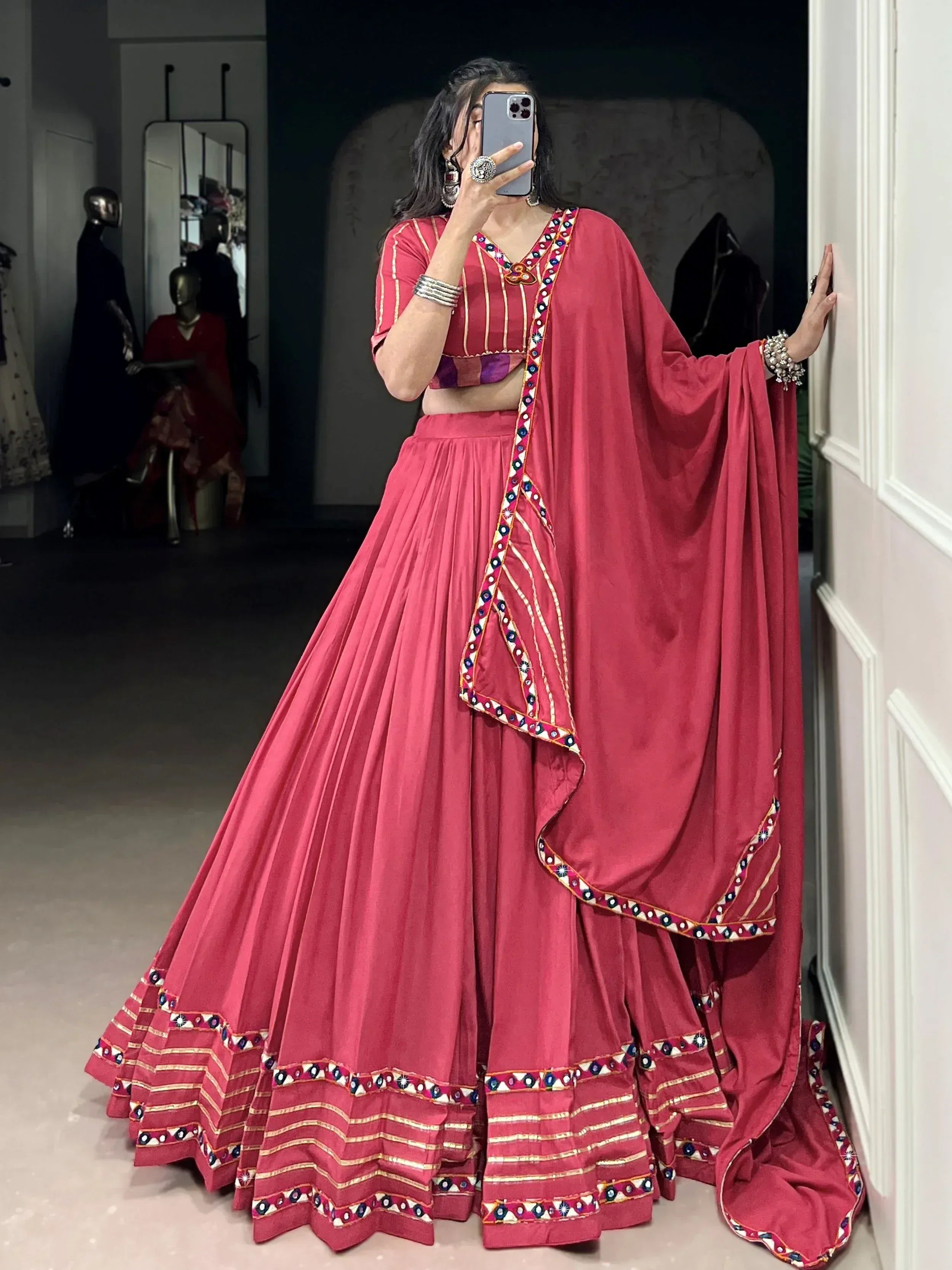 Red ethnic lehenga choli with mirror work and dupatta, perfect for Indian weddings and festive occasions